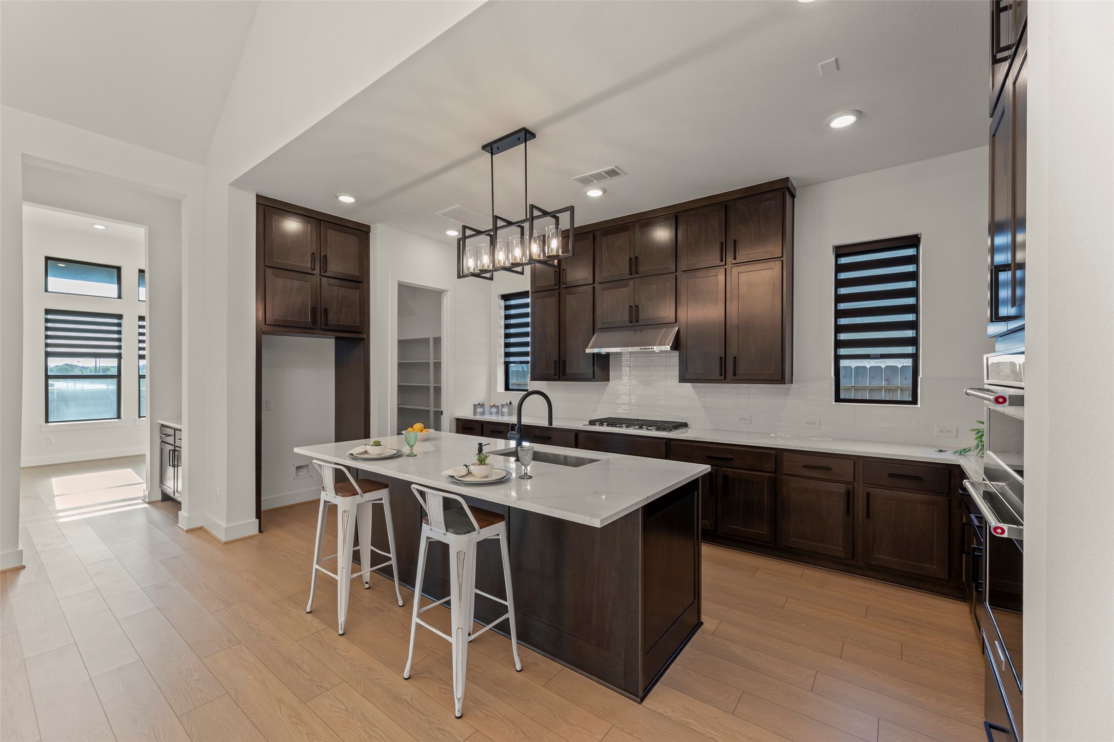 Elegant kitchen featuring dark wood cabinetry.