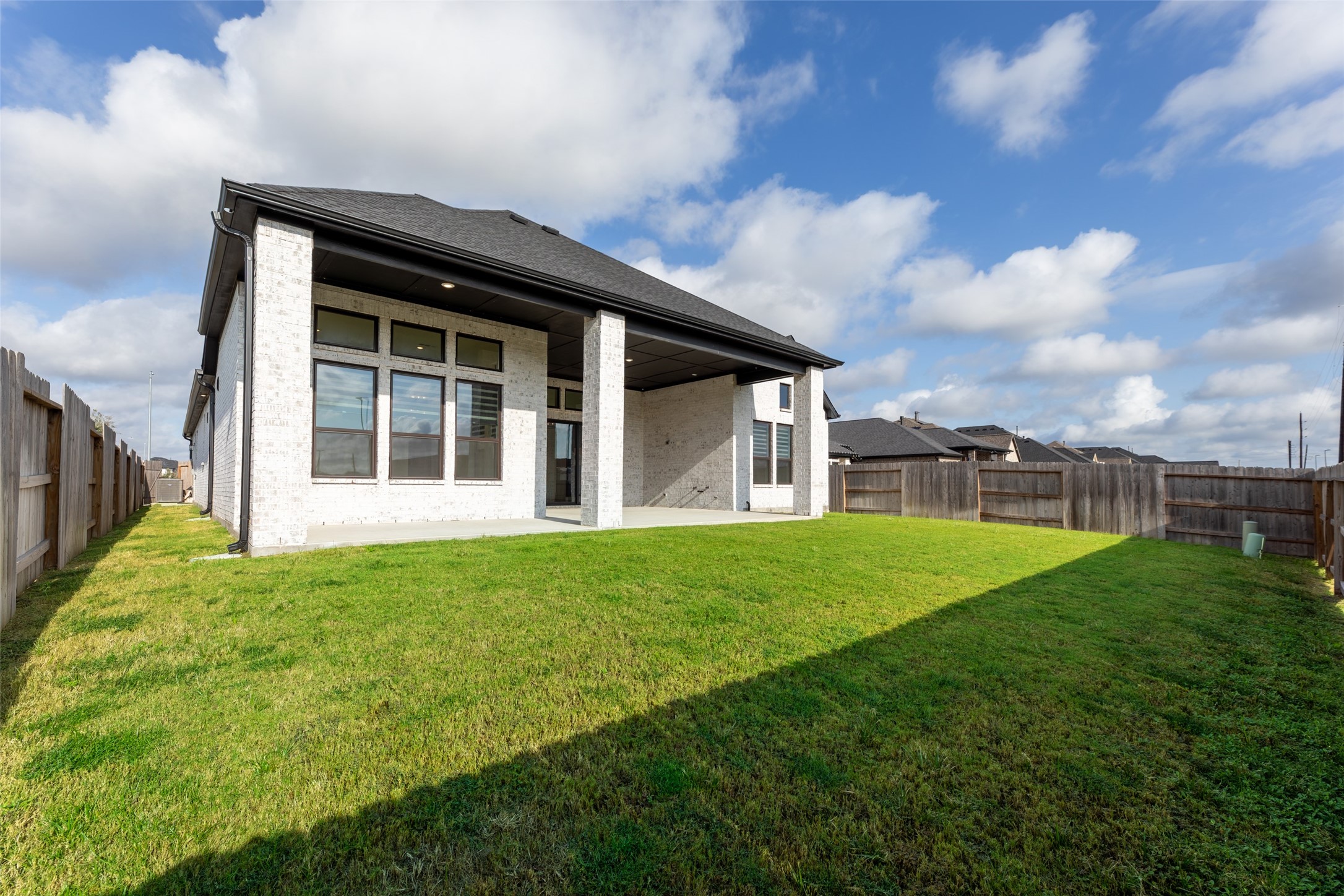 Covered patio, and modern exterior, perfect for outdoor enjoyment and entertaining.