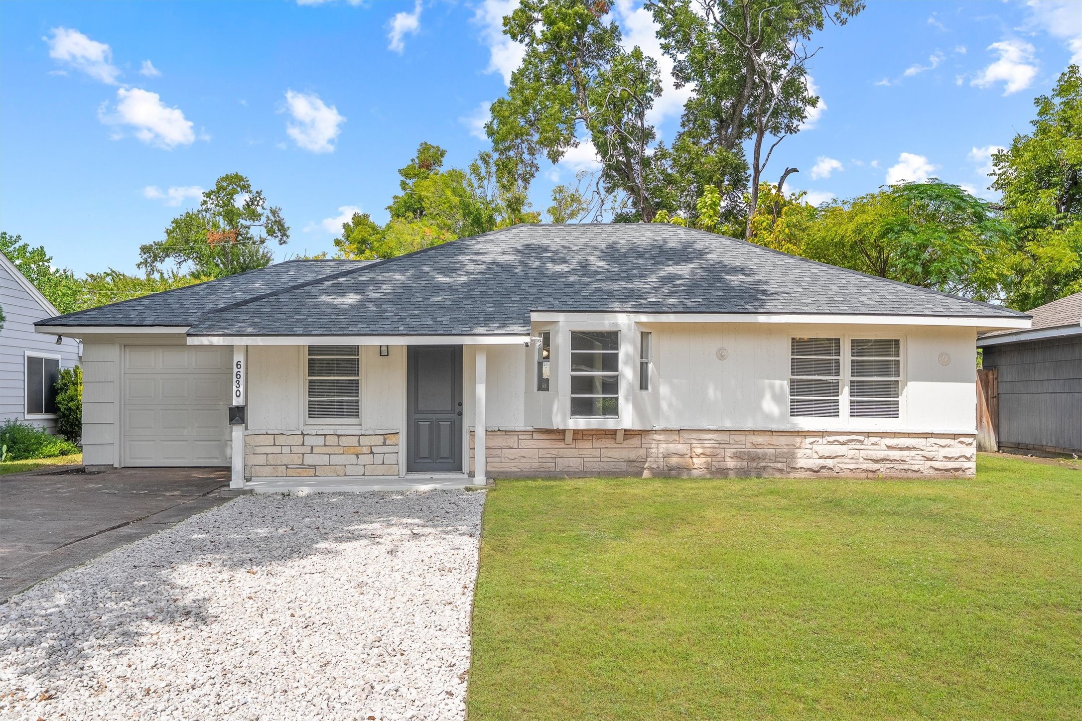 Attractive single-story home with a fresh, modern exterior, featuring a well-maintained lawn, a sleek gray roof, and an attached garage. Attractive single-story home with a fresh, modern exterior, featuring a well-maintained lawn, a sleek gray roof, and an attached garage.