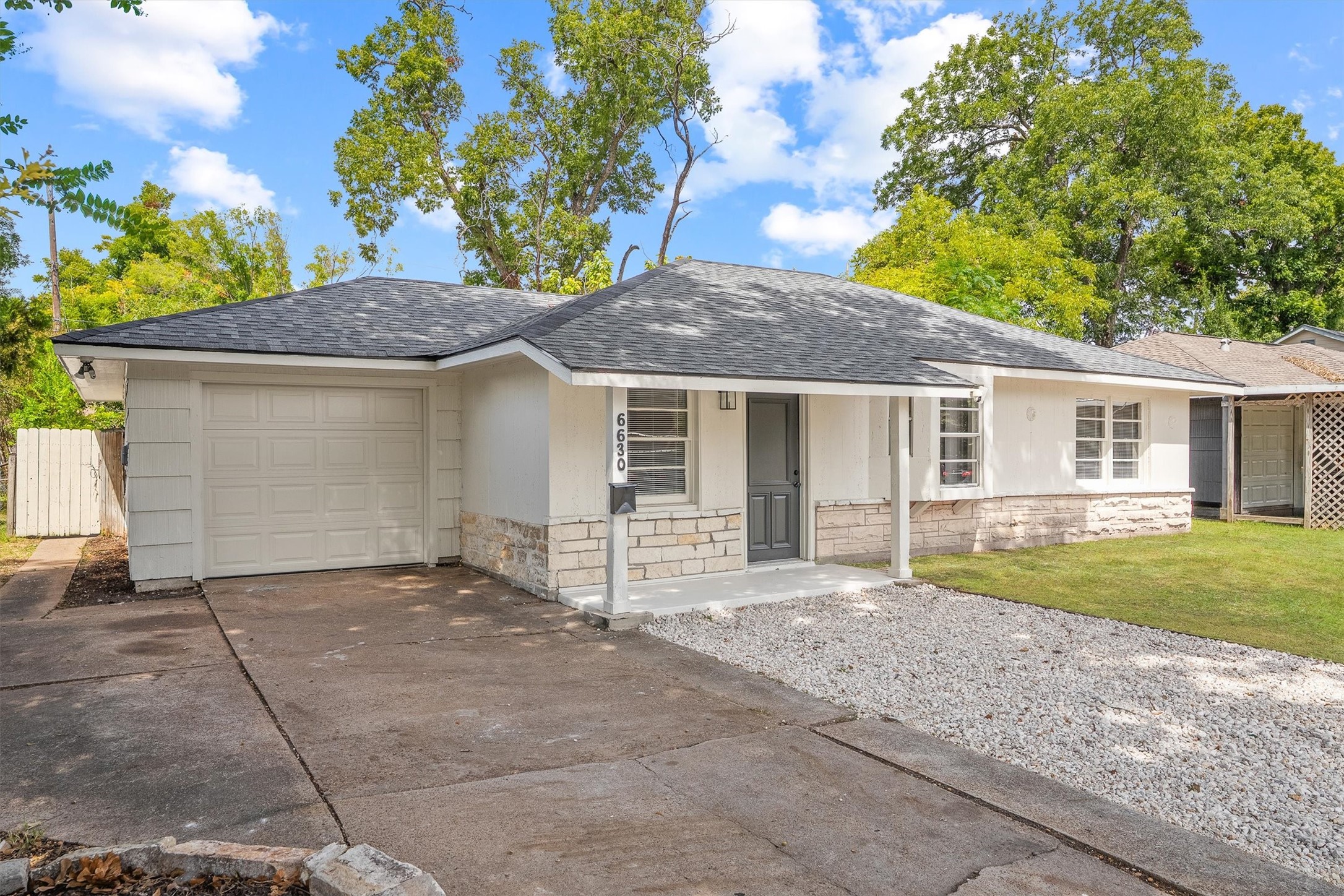 Charming single-story home featuring a clean, modern facade with stone accents, a spacious driveway, and a lush green lawn, perfect for easy living. Charming single-story home featuring a clean, modern facade with stone accents, a spacious driveway, and a lush green lawn, perfect for easy living.