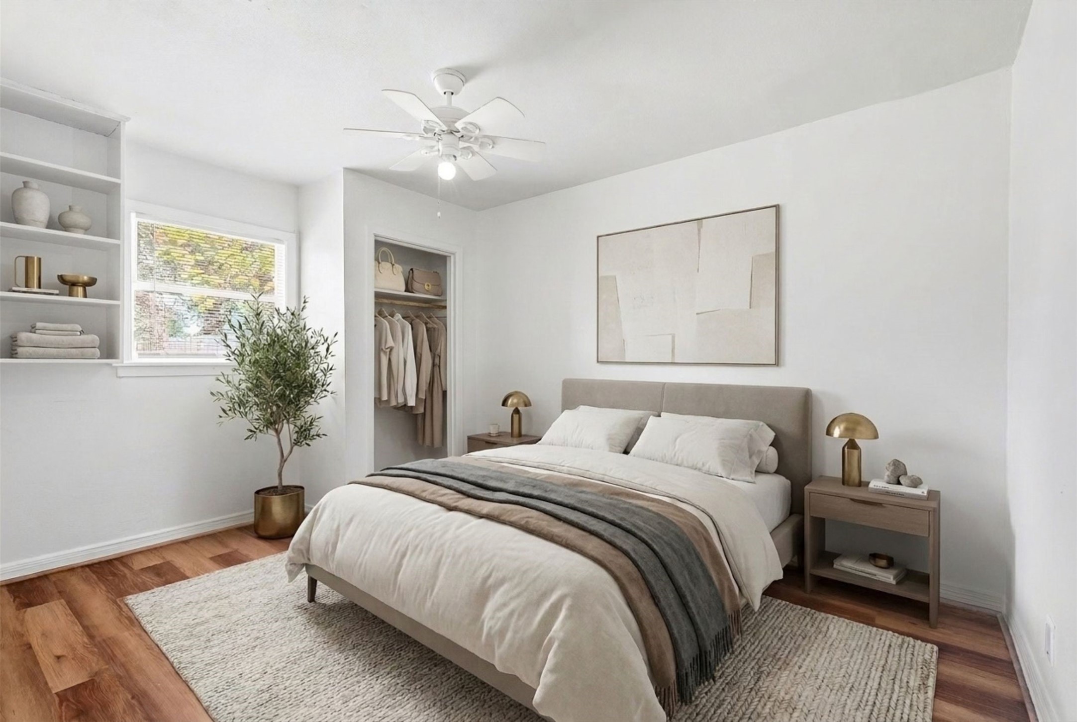 Experience serene comfort in this bedroom, featuring elegant built-in shelving, warm wood flooring, and abundant natural light for a peaceful retreat. (Virtual Staging)