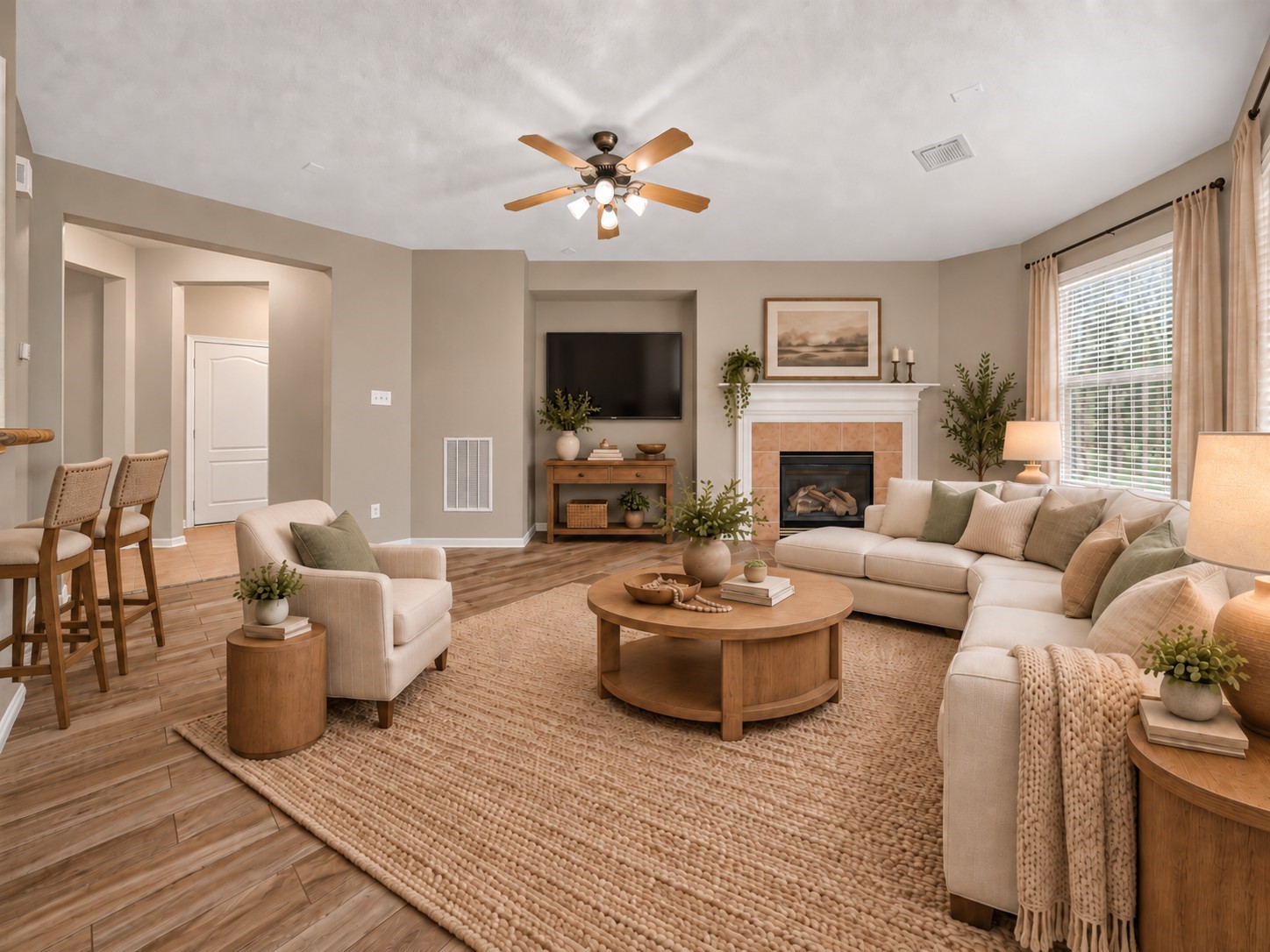 The inviting family room is anchored by a cozy fireplace, creating a warm focal point for the space. A ceiling fan adds everyday comfort while keeping the room feeling relaxed and welcoming. **Virtually Staged**