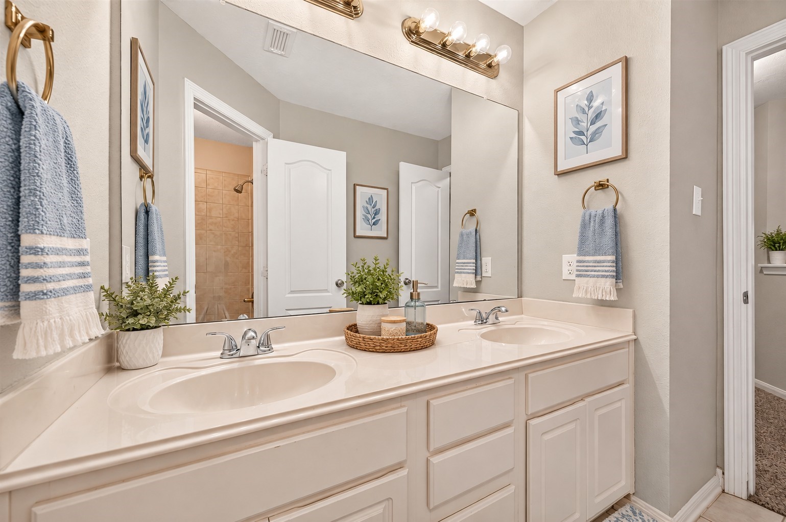 The upstairs secondary full bathroom features double sinks, generous cabinet storage, and a large mirror that helps keep the space feeling bright and open. A practical setup with plenty of room for shared daily routines. **Virtually Staged**