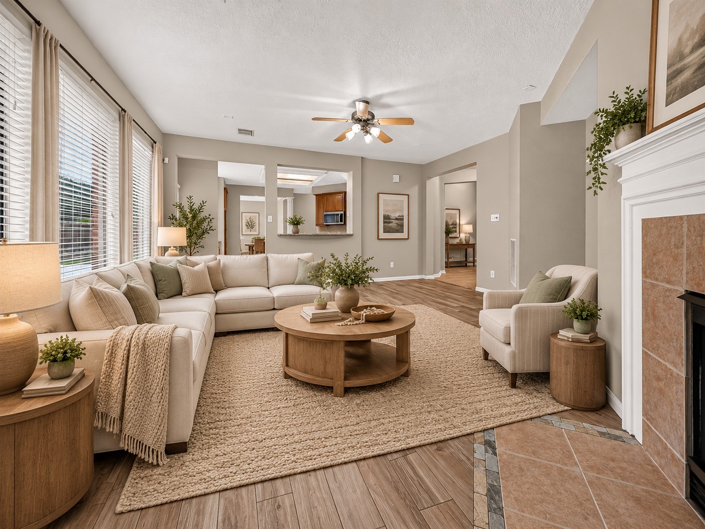 A wall of windows with blinds brings plenty of natural light into the family room, while tile flooring offers easy everyday care. The open layout flows seamlessly into the kitchen, creating a comfortable space for daily living and entertaining. **Virtually Staged**