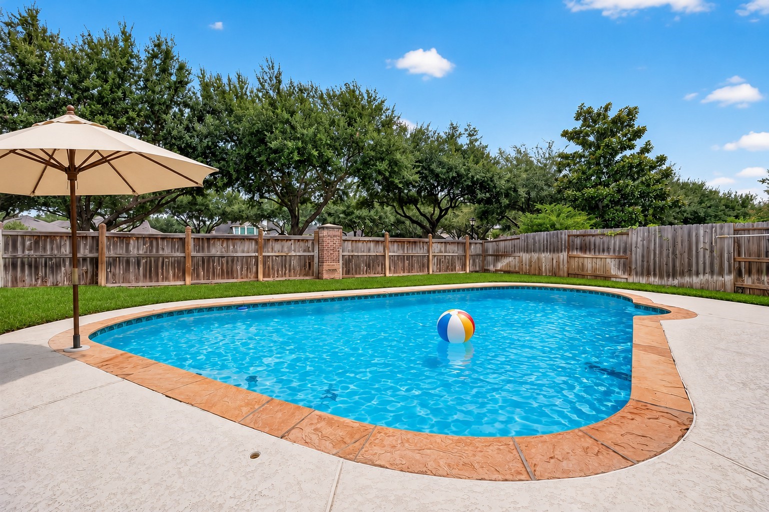 Your own backyard oasis awaitsdip your toes in or make a splash while enjoying a staycation at home. With plenty of space for fun, relaxation, and entertaining, this backyard is ready to be enjoyed. **Pool umbrella & beach ball virtually staged.**