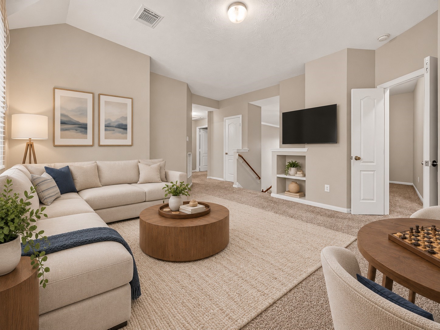 Upstairs to the left, the game room offers a flexible area for relaxing, watching TV, or enjoying game night. Built-in shelves add convenient display and storage space while keeping the room open and functional. **Virtually Staged**