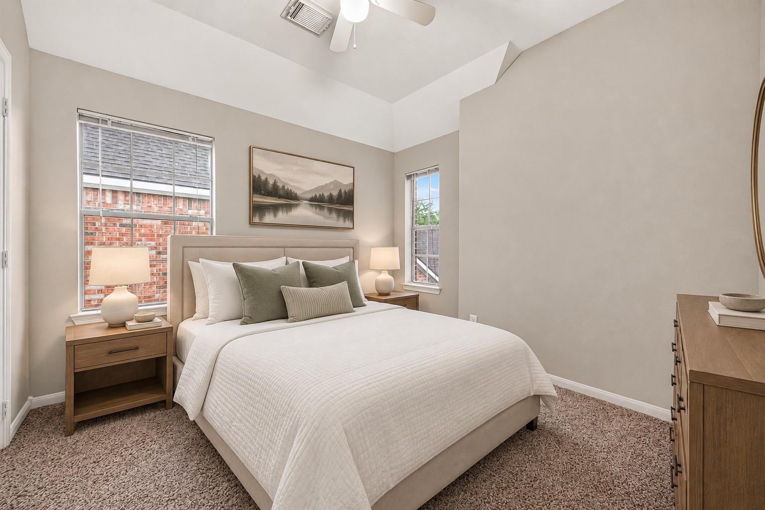 The second guest bedroom features two windows that bring in plenty of natural light, creating a bright and welcoming space. Plush carpet adds warmth and comfort underfoot. **Virtually Staged**