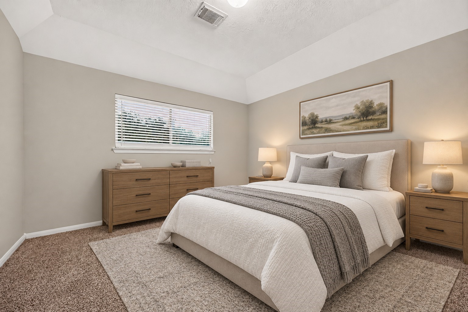 This guest bedroom features a large window with blinds that brings in plenty of natural light. The recessed ceiling adds architectural interest and gives the room a spacious, comfortable feel. **Virtually Staged**
