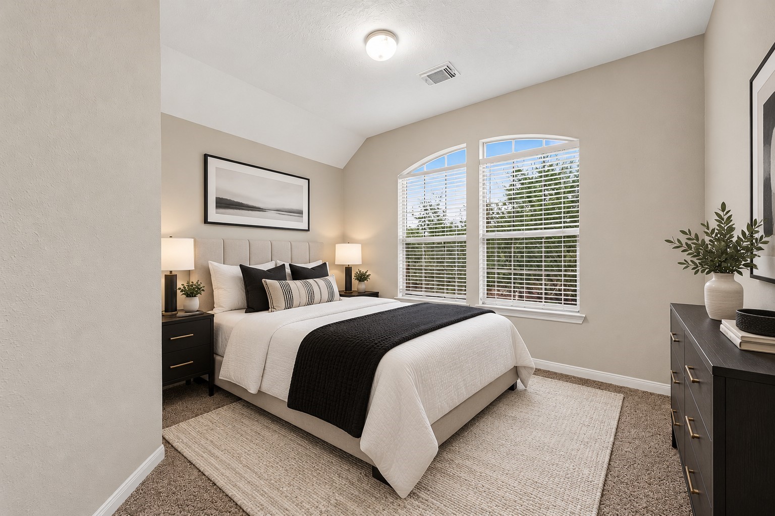 The third guest bedroom features large windows with blinds, filling the space with natural light. Plush carpet adds warmth and comfort, creating a welcoming retreat for family or guests. **Virtually Staged**