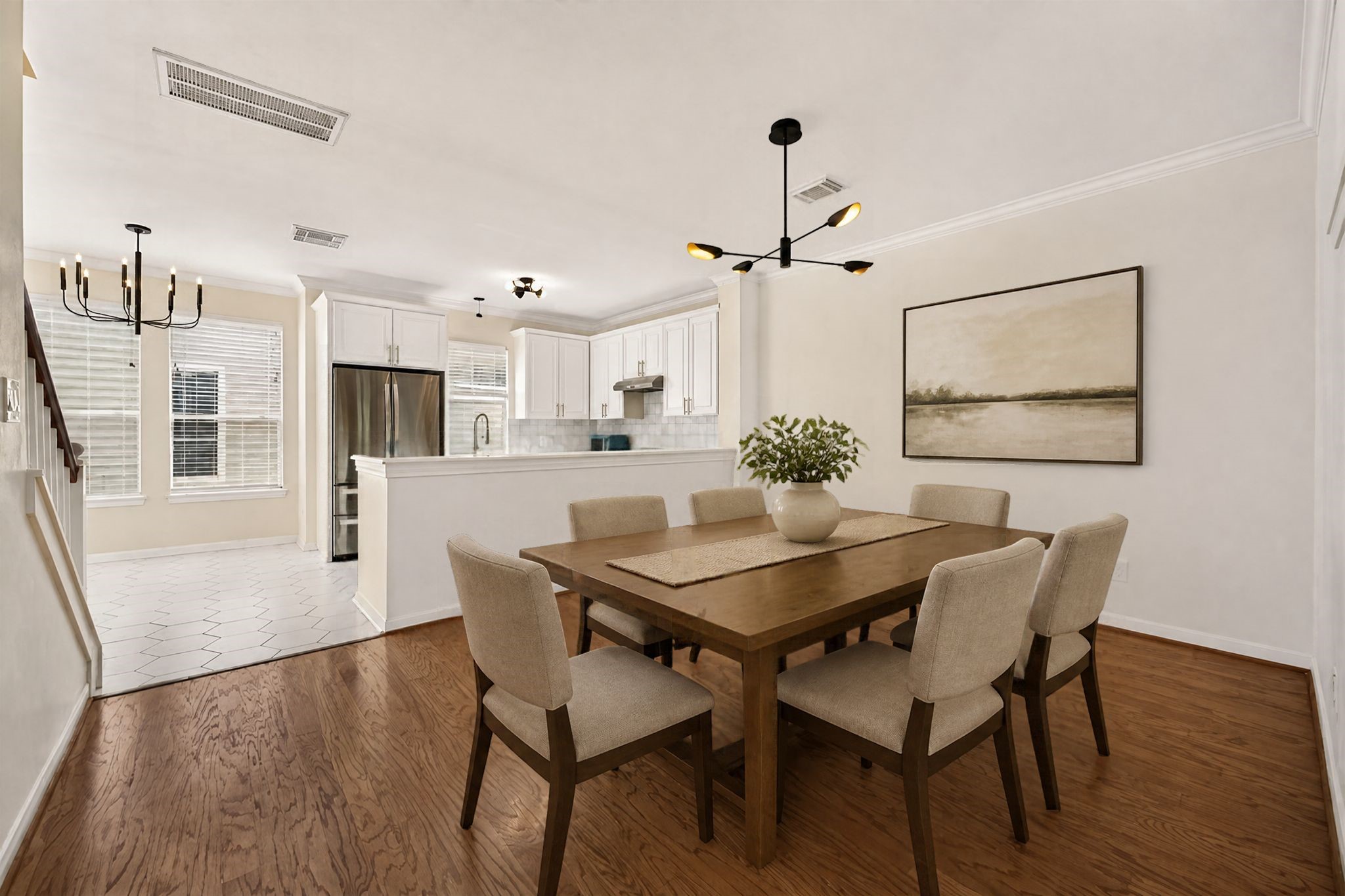 Virtually staged Dining room, fresh paint with a new modern light fixture.