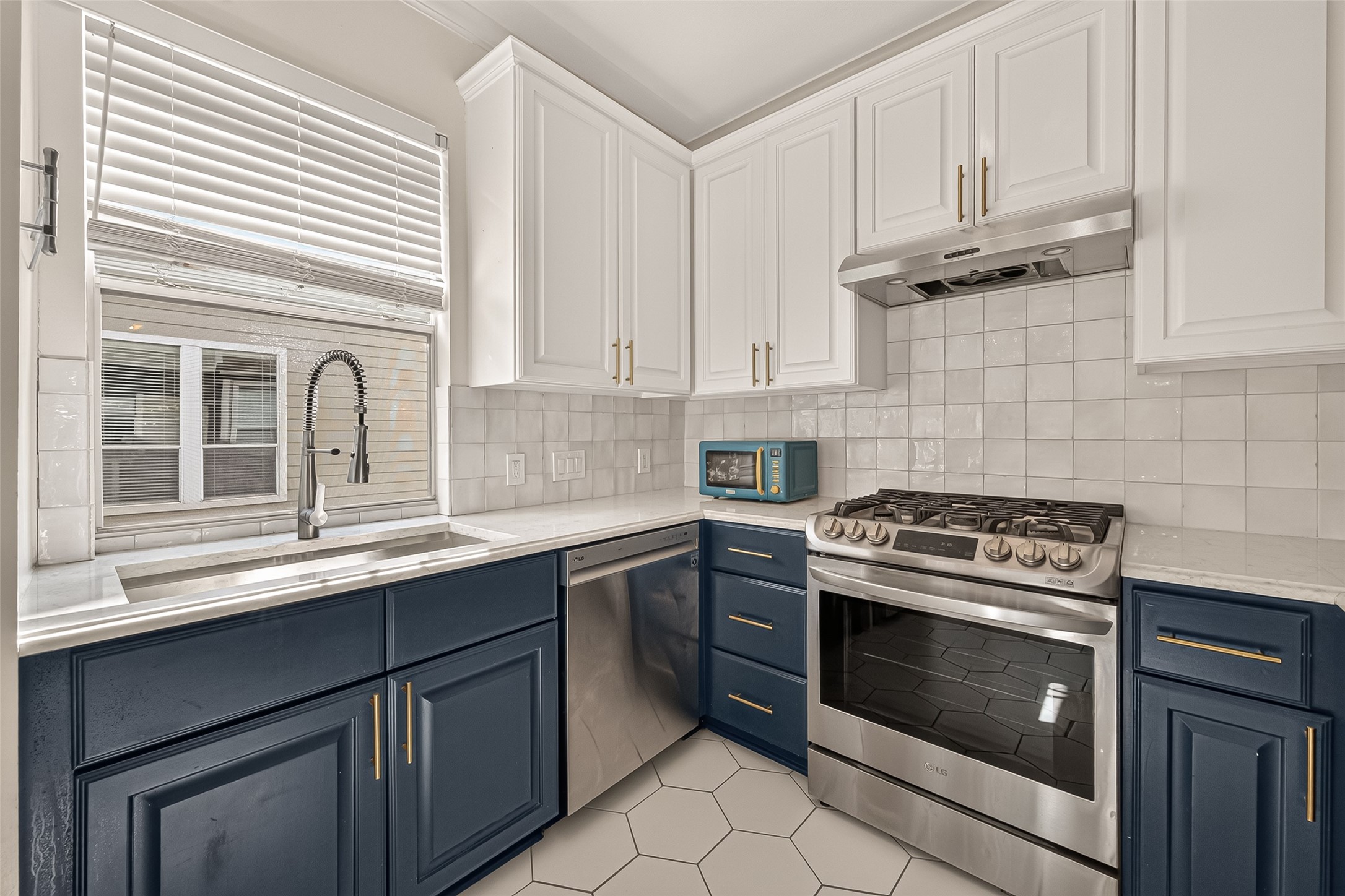 Bright, inviting kitchen featuring a window over the sink that brings in natural sunlight.