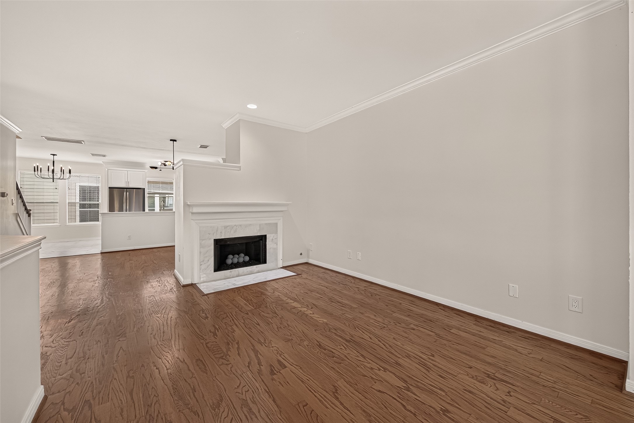 The fireplace serves as the focal point of the living room, adding a fresh, modern touch while bringing the surrounding spaces together.