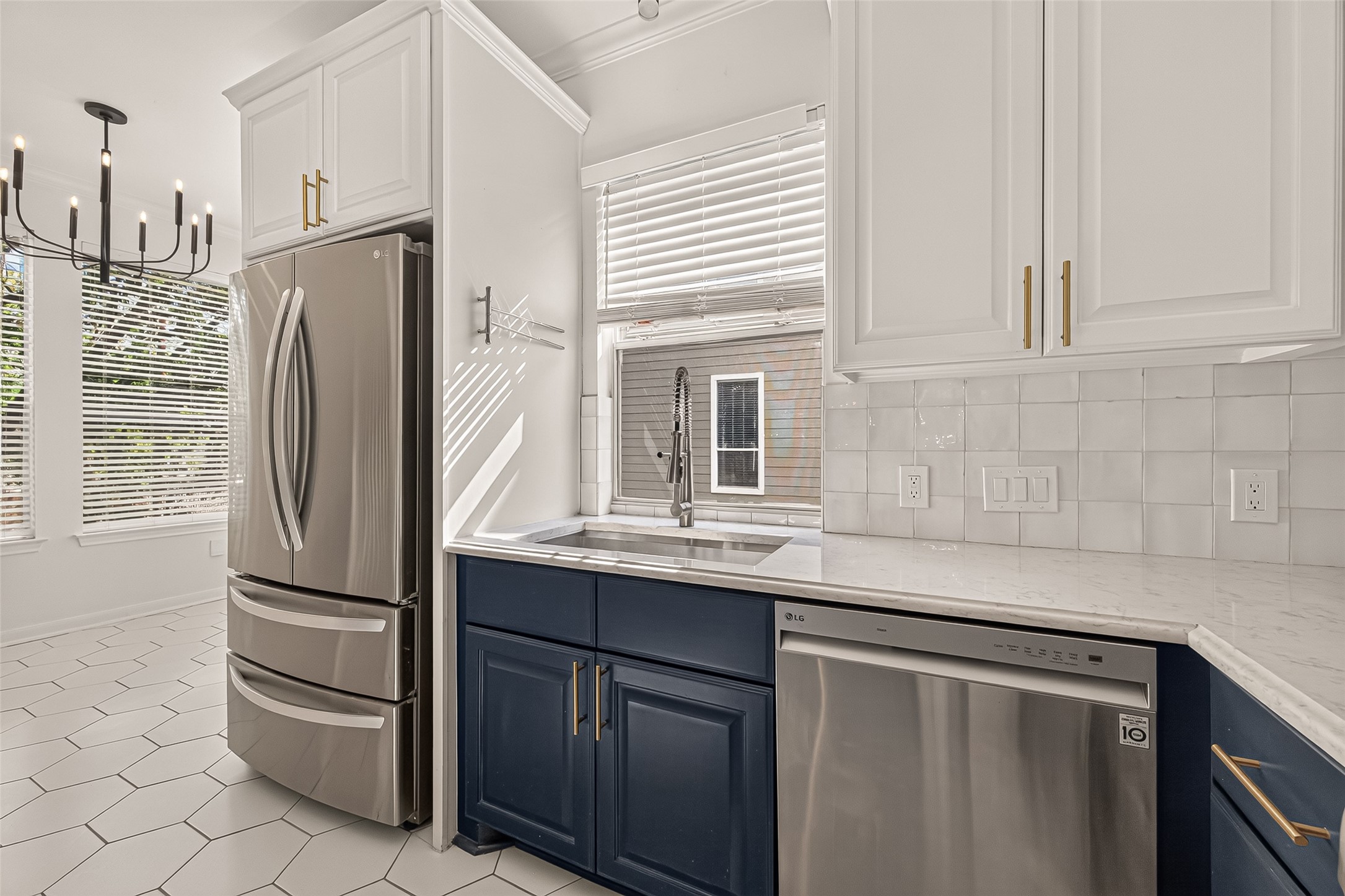 Sleek, modern appliances, including the refrigerator and dishwasher, complement the kitchens updated design.