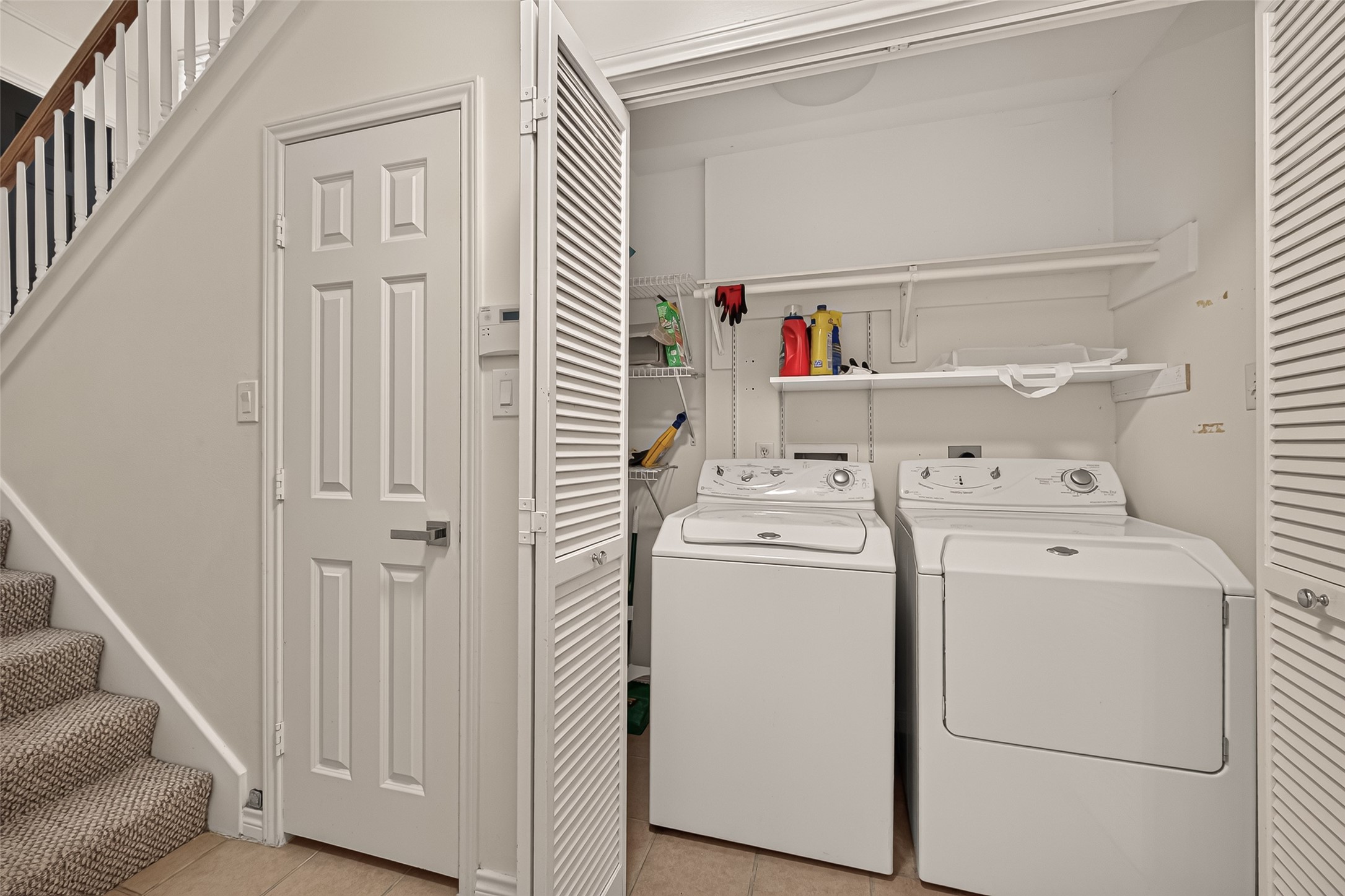 Convenient first-floor laundry closet with washer and dryer included, plus additional space for laundry supplies and household items.