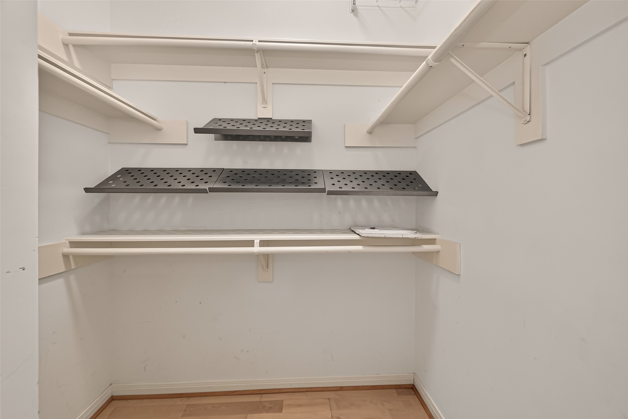The spacious hall walk-in closet offers versatile storage possibilities for linens, seasonal items, or household essentials.