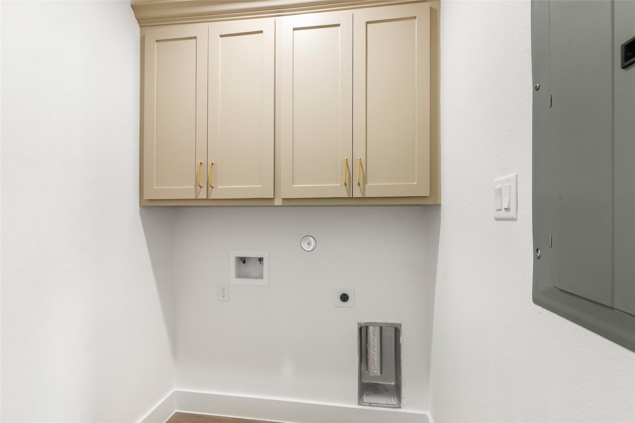 Laundry room has cabinetry storage.