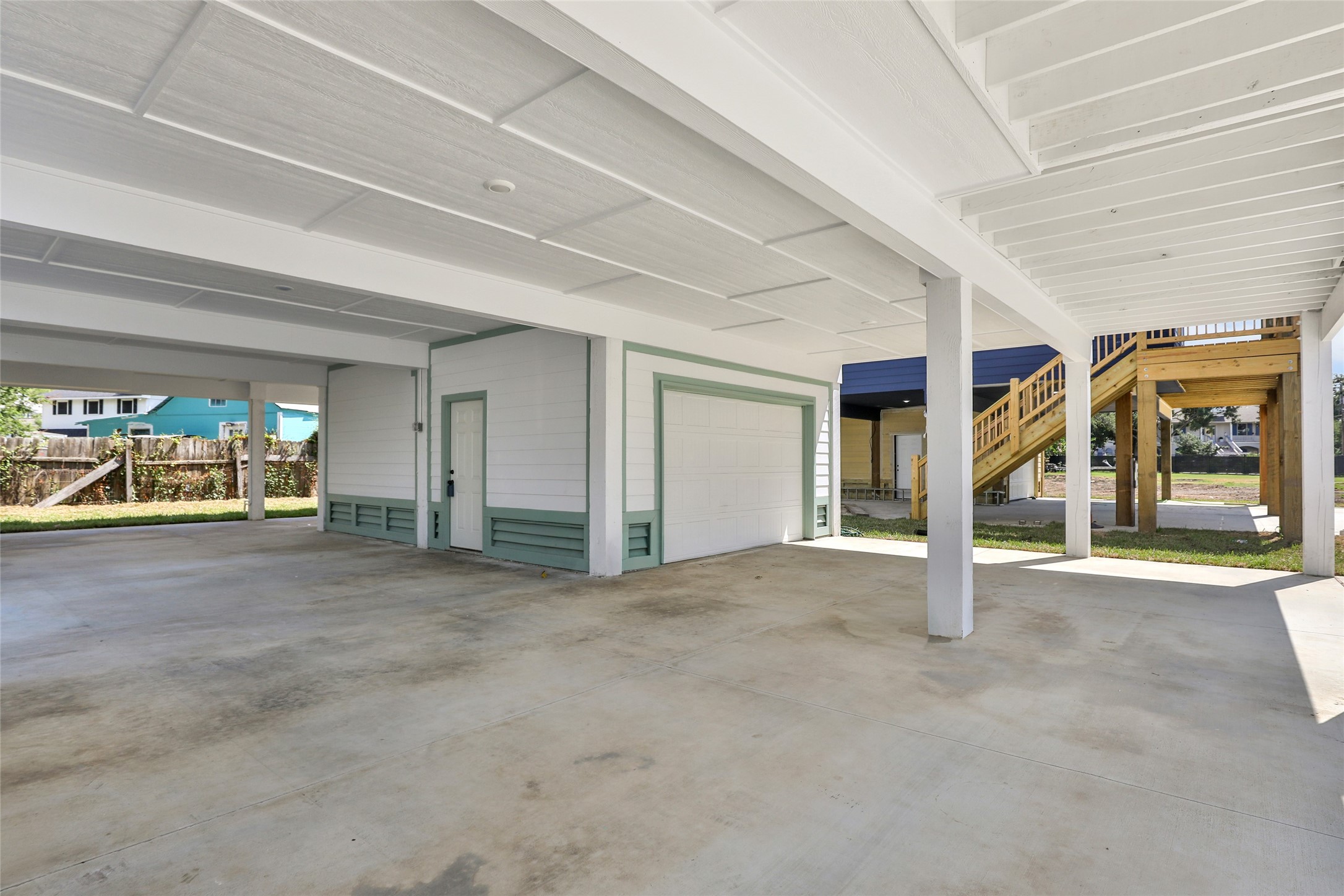 Spacious covered parking area and storage area.