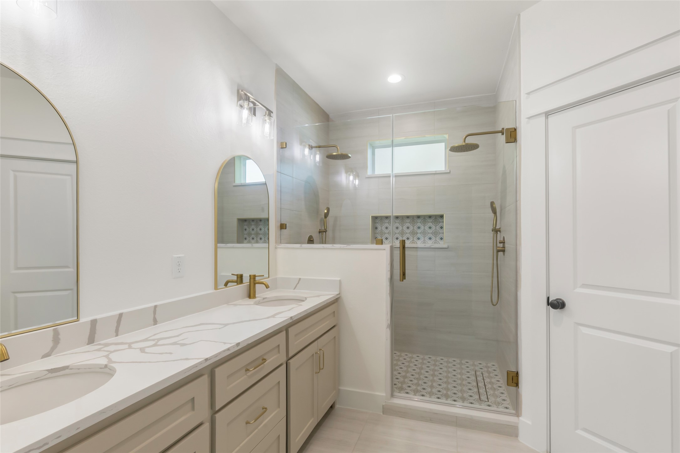 Primary bath has double sink vanity and an elegant shower featuring dual shower heads for a spa-like retreat. Primary bath has double sink vanity and an elegant shower featuring dual shower heads for a spa-like retreat.