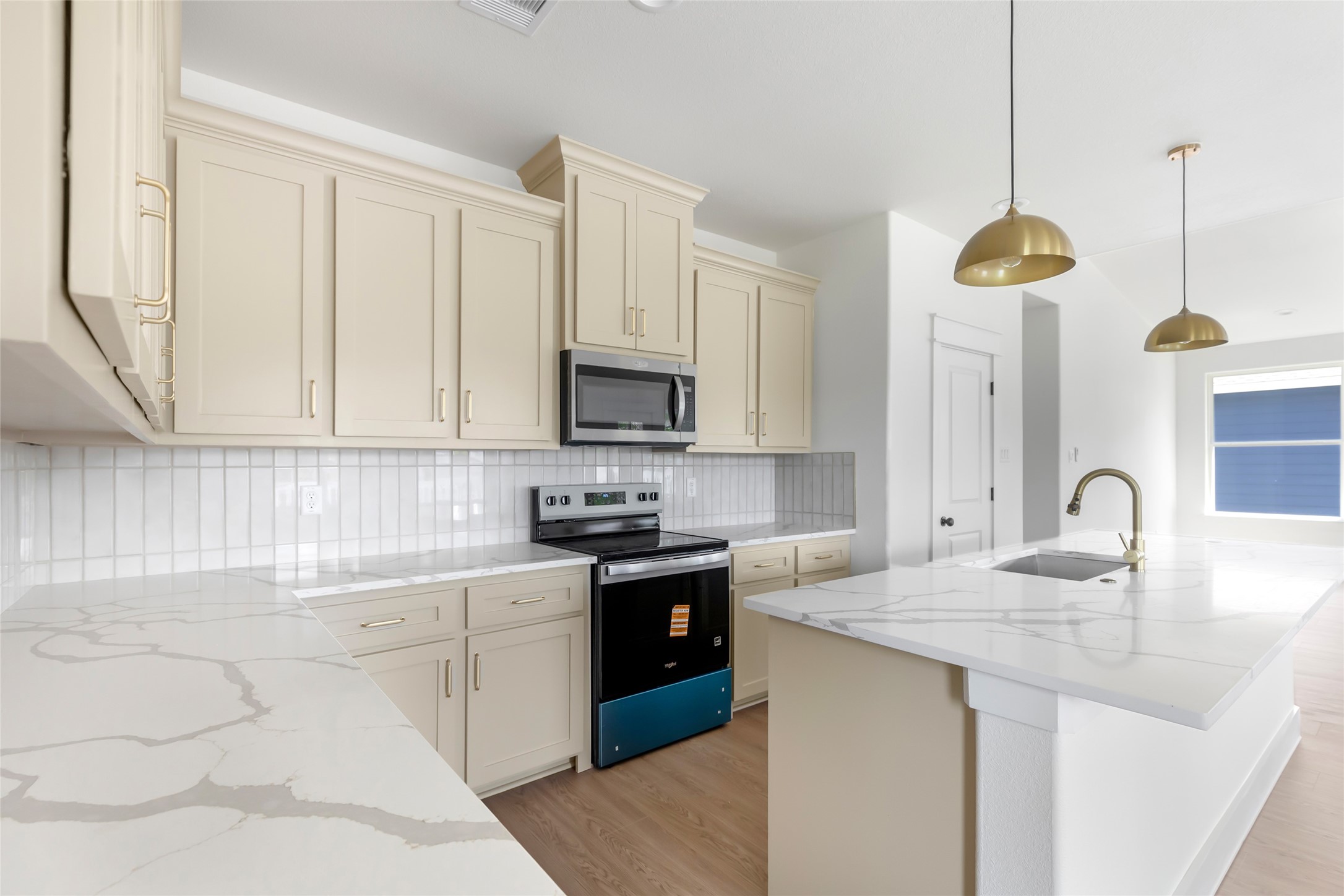 Ample cabinetry with soft-close features and elegant brushed gold fixtures that enhance the kitchen's design. Ample cabinetry with soft-close features and elegant brushed gold fixtures that enhance the kitchen's design.