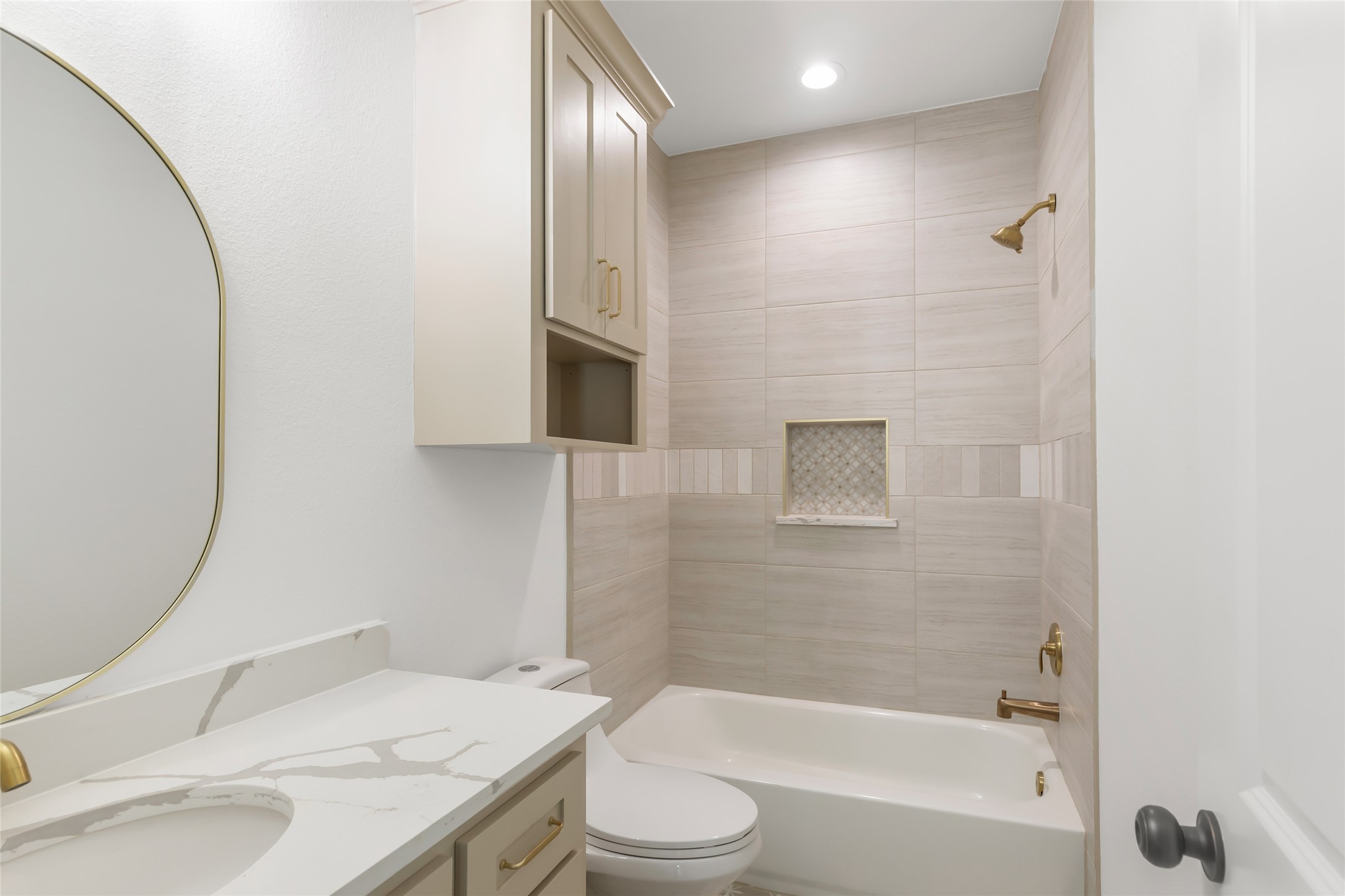Secondary bathroom with tub shower. combination. Quartz counters and stylish tile accents.