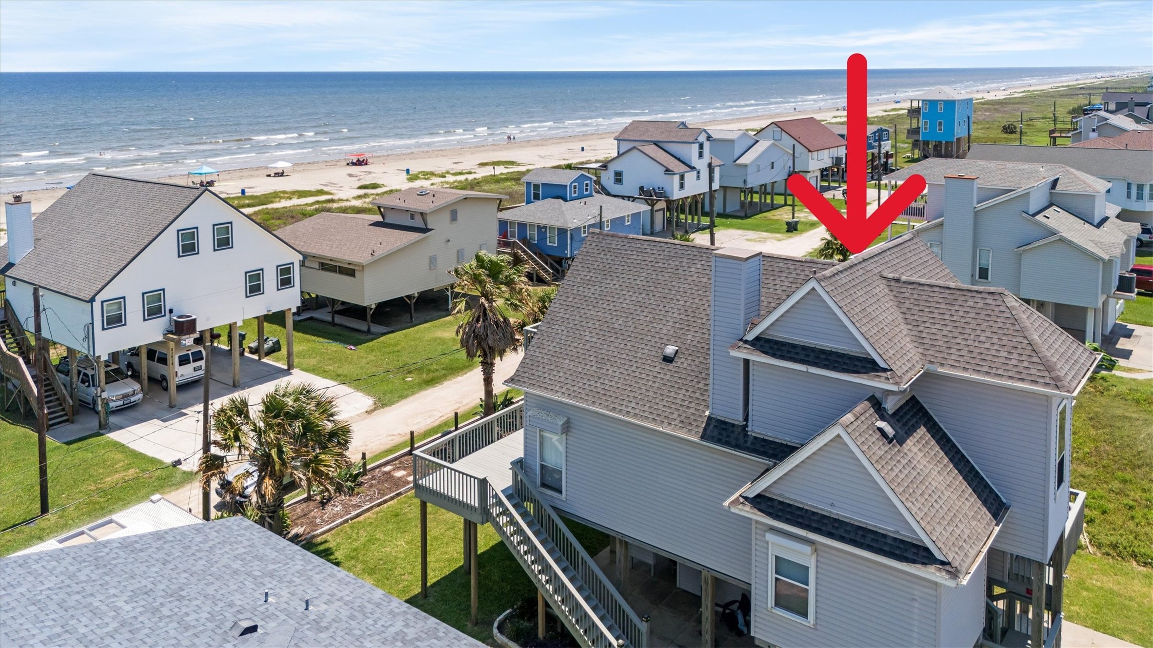 This beachside home offers stunning ocean views and is situated just steps from the beach. It features a spacious deck, ideal for relaxing and enjoying the coastal breeze. Perfect for those seeking a serene seaside lifestyle.