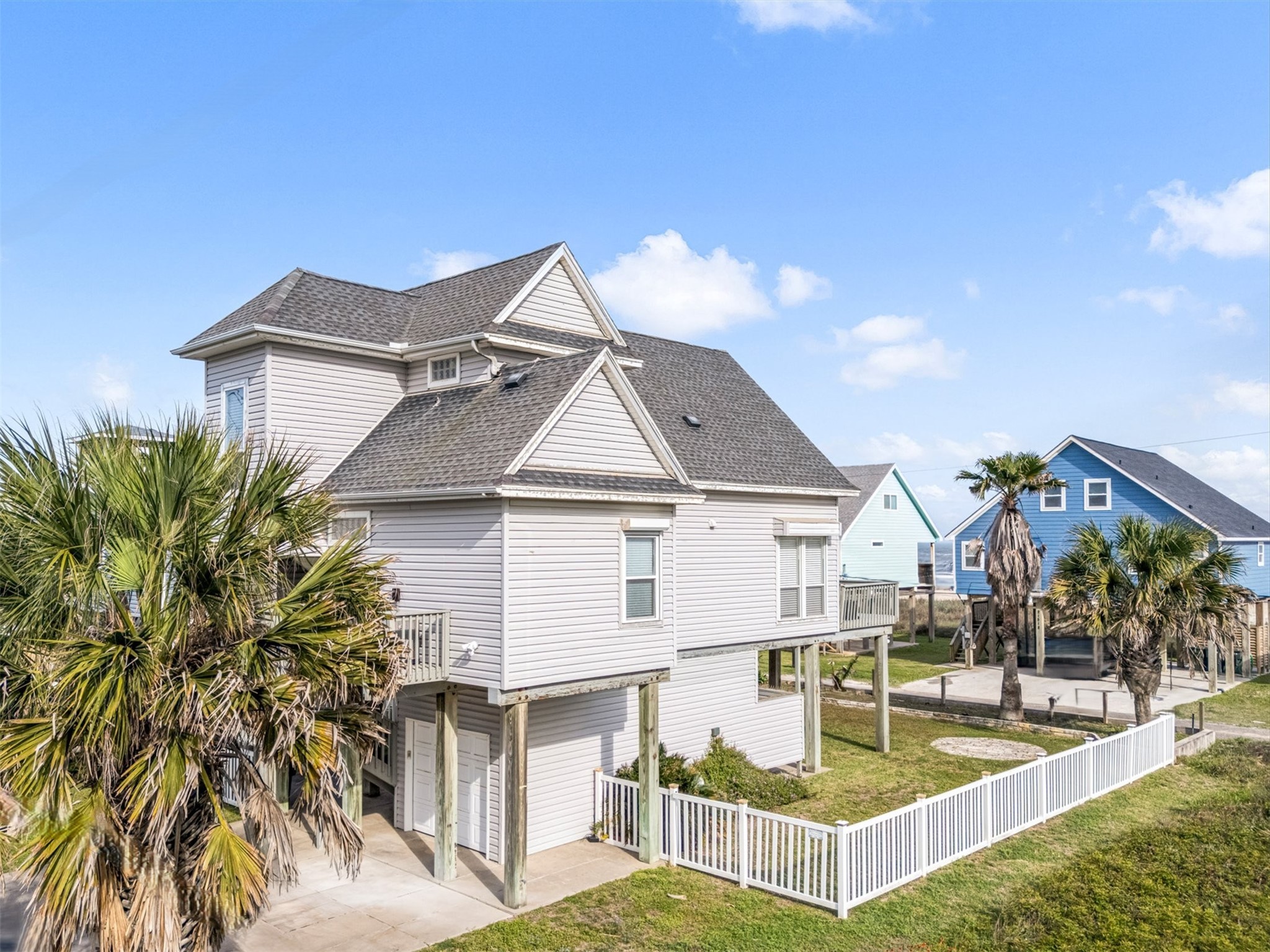 The property offers a partially fenced yard, open to the beach access.  The wide driveway provides extra parking space and the 1-car garage is great for enclosed parking or ample storage space.