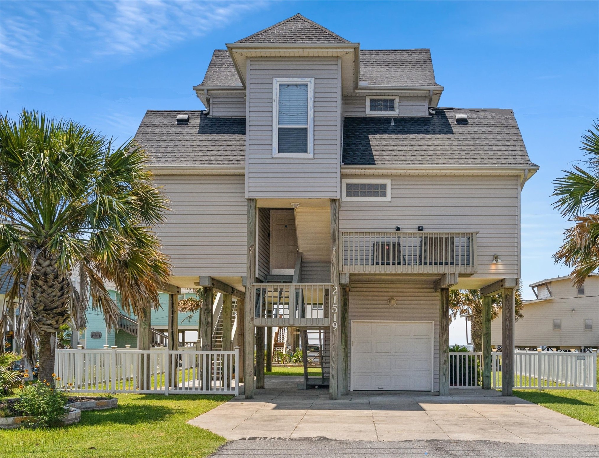 Discover your coastal retreat on San Luis Pass Road, featuring an inviting elevated design with an extra-wide driveway for ample parking space.