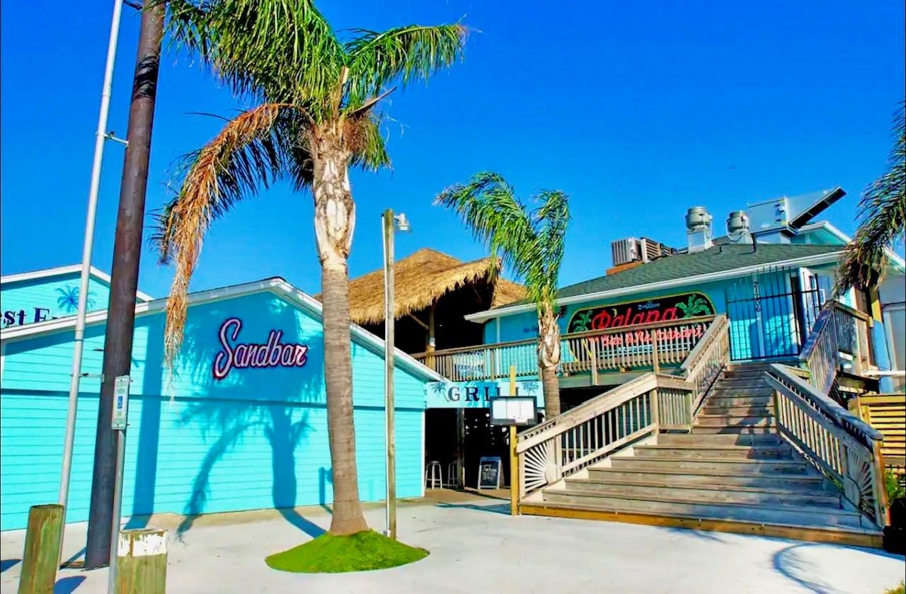 Discover vibrant waterfront dining at "The Restaurant at the Marina," where palm trees sway and coastal charm invites you to savor island-inspired flavors in a bright, relaxed atmosphere.