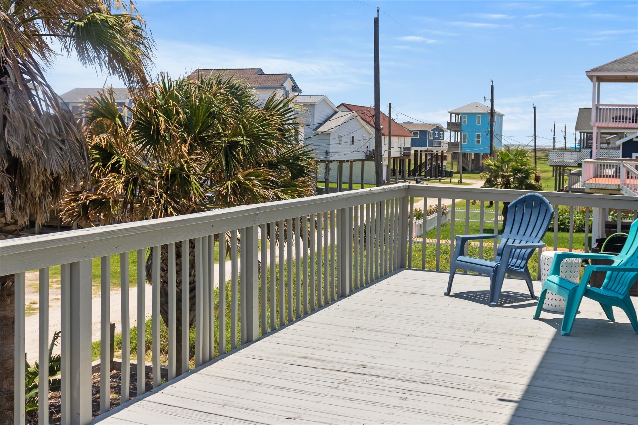 This photo showcases a spacious deck big enough for seating, offering a view of the nearby beach. The setting is perfect for enjoying outdoor relaxation and scenic surroundings.