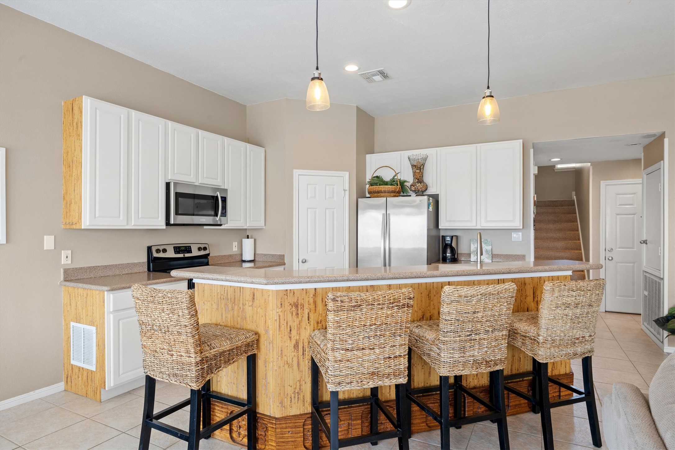 Adjacent to the dining area is an expansive bar with abundant seating, when paired with the table makes for perfect casual dining and entertaining.
