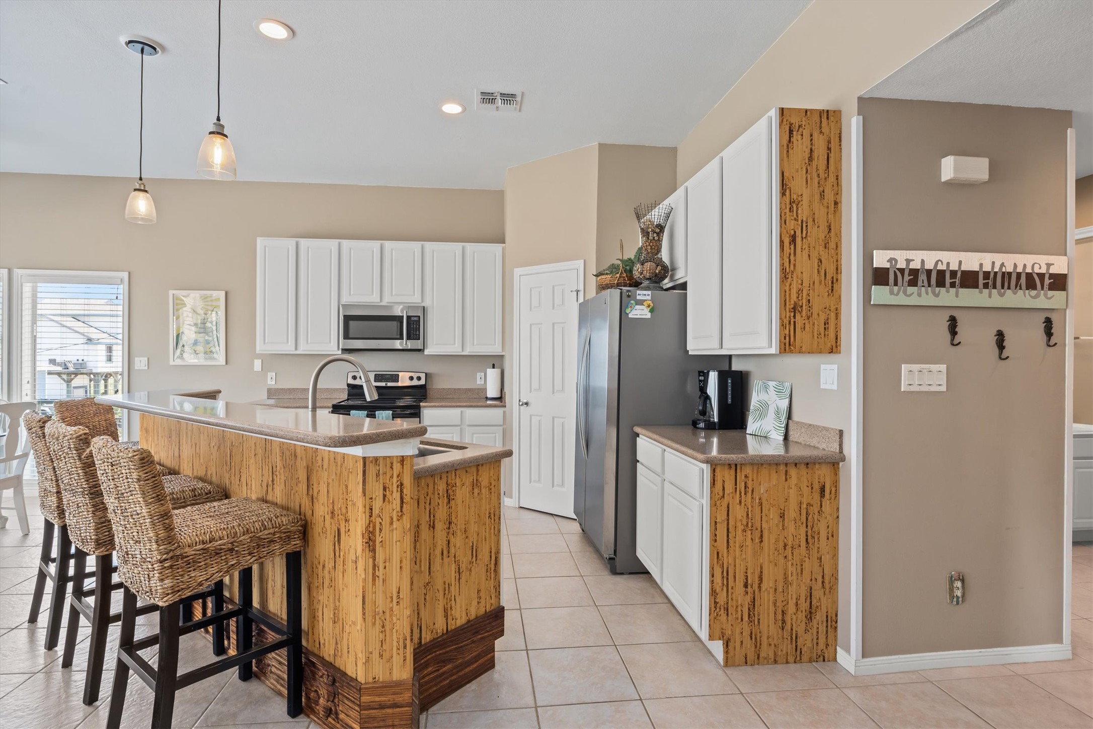 This inviting kitchen boasts abundant storage and expansive counter space, perfect for culinary adventures and entertaining guests.