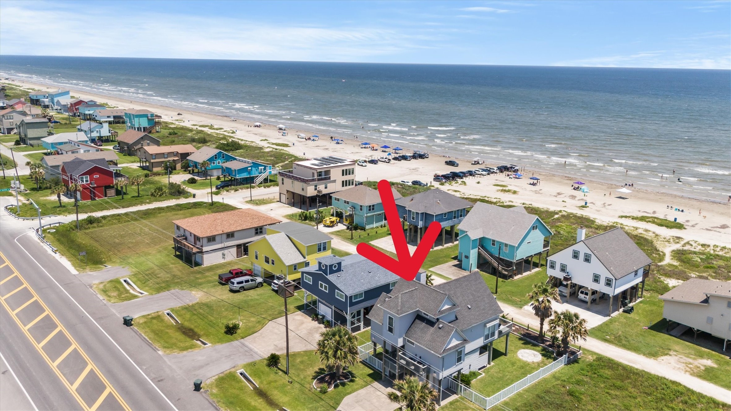 This coastal property offers stunning beach views and immediate access to the shore. The home is part of a charming neighborhood with colorful houses and is perfect for enjoying seaside living.