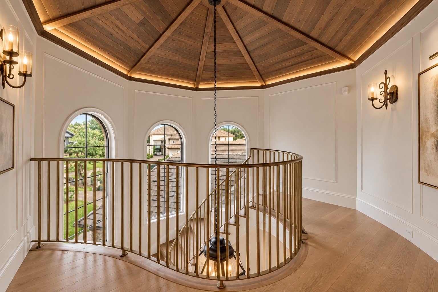 Beautiful ceiling geometry, architectural windows, and intricate stair railing details create an elegant upper-level landing that reflects the home's exceptional attention to design.