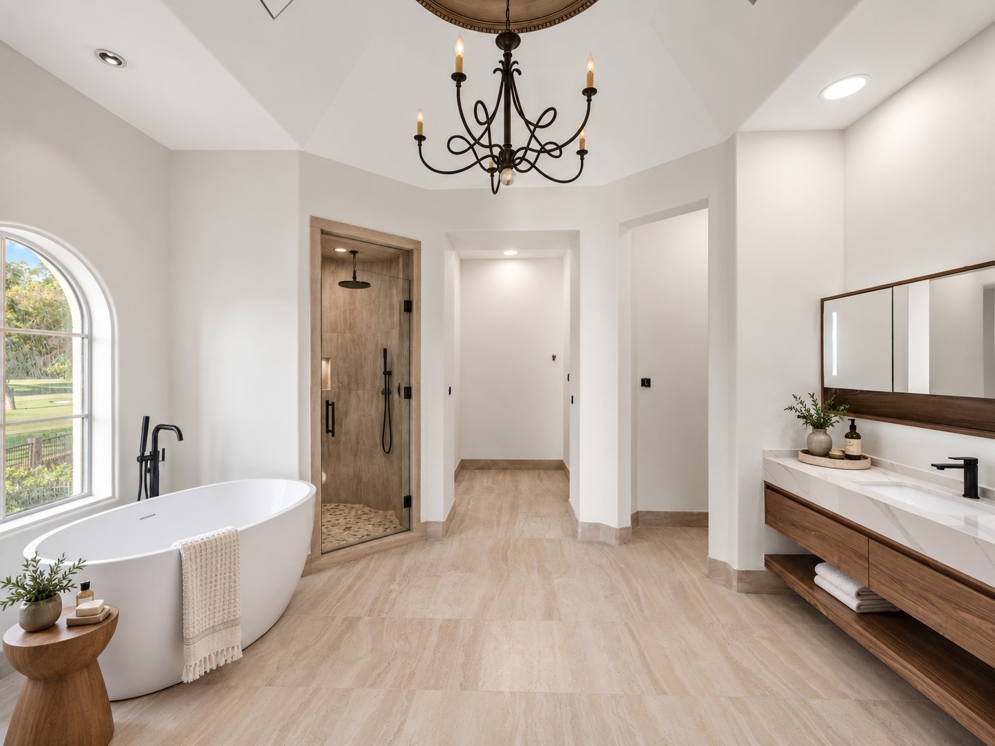 A light-filled bathroom features a freestanding soaking tub, refined cabinetry, elegant fixtures, and thoughtfully appointed finishes, offering a private and comfortable experience for guests or family.
