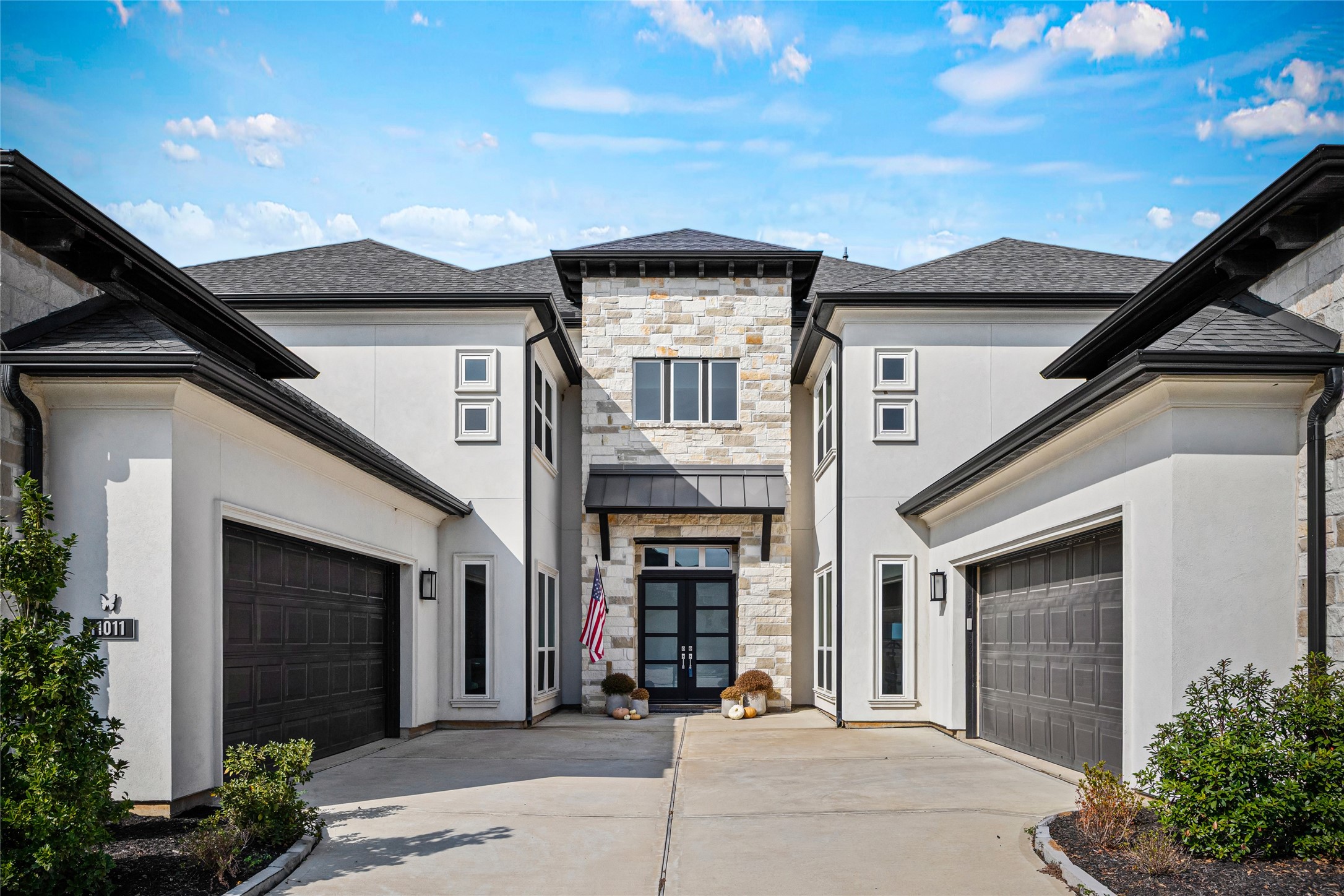Dual-facing garages with a spacious driveway create a luxurious and private feel