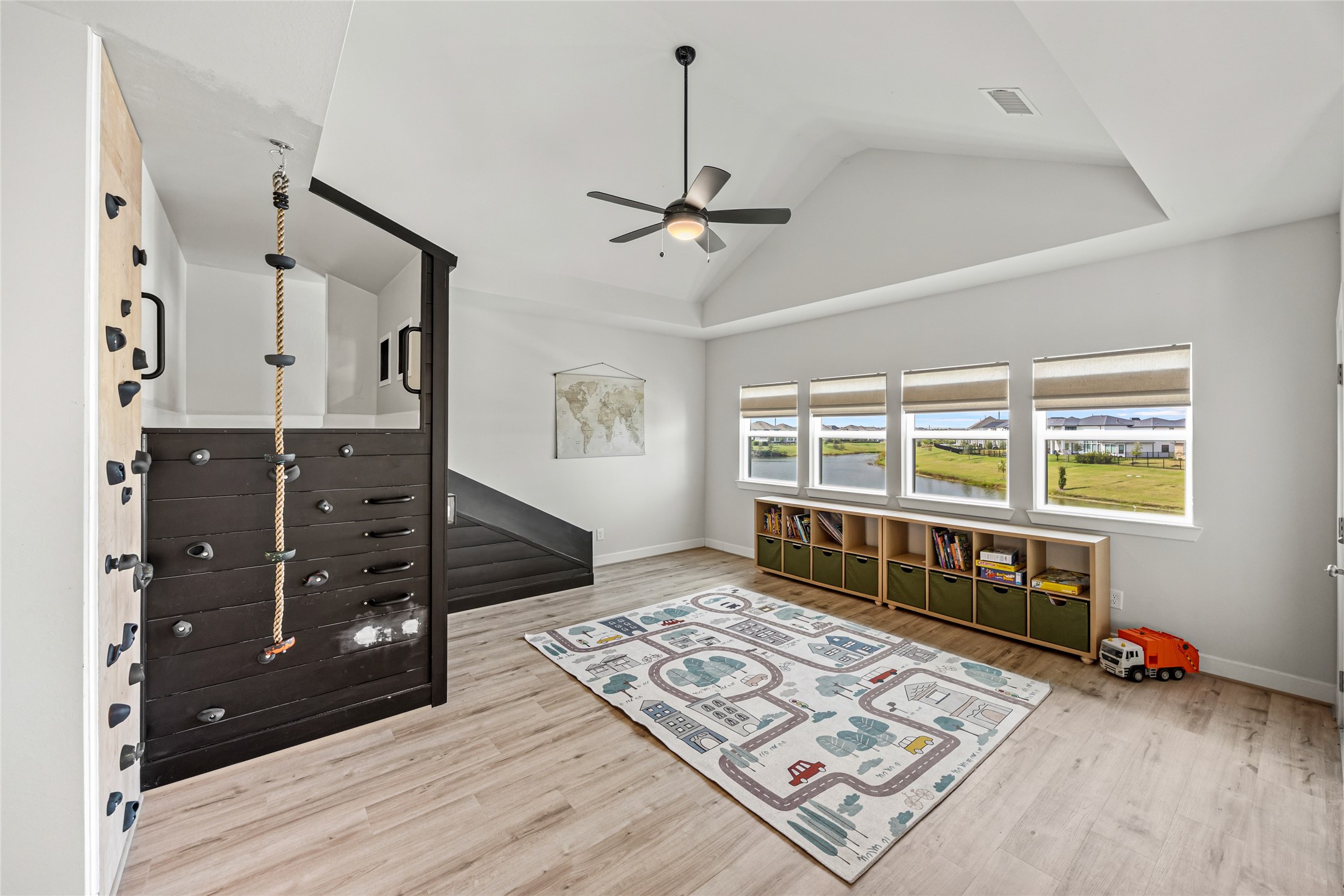 Play area with built-in rock climbing wall and versatile space for childrens activities