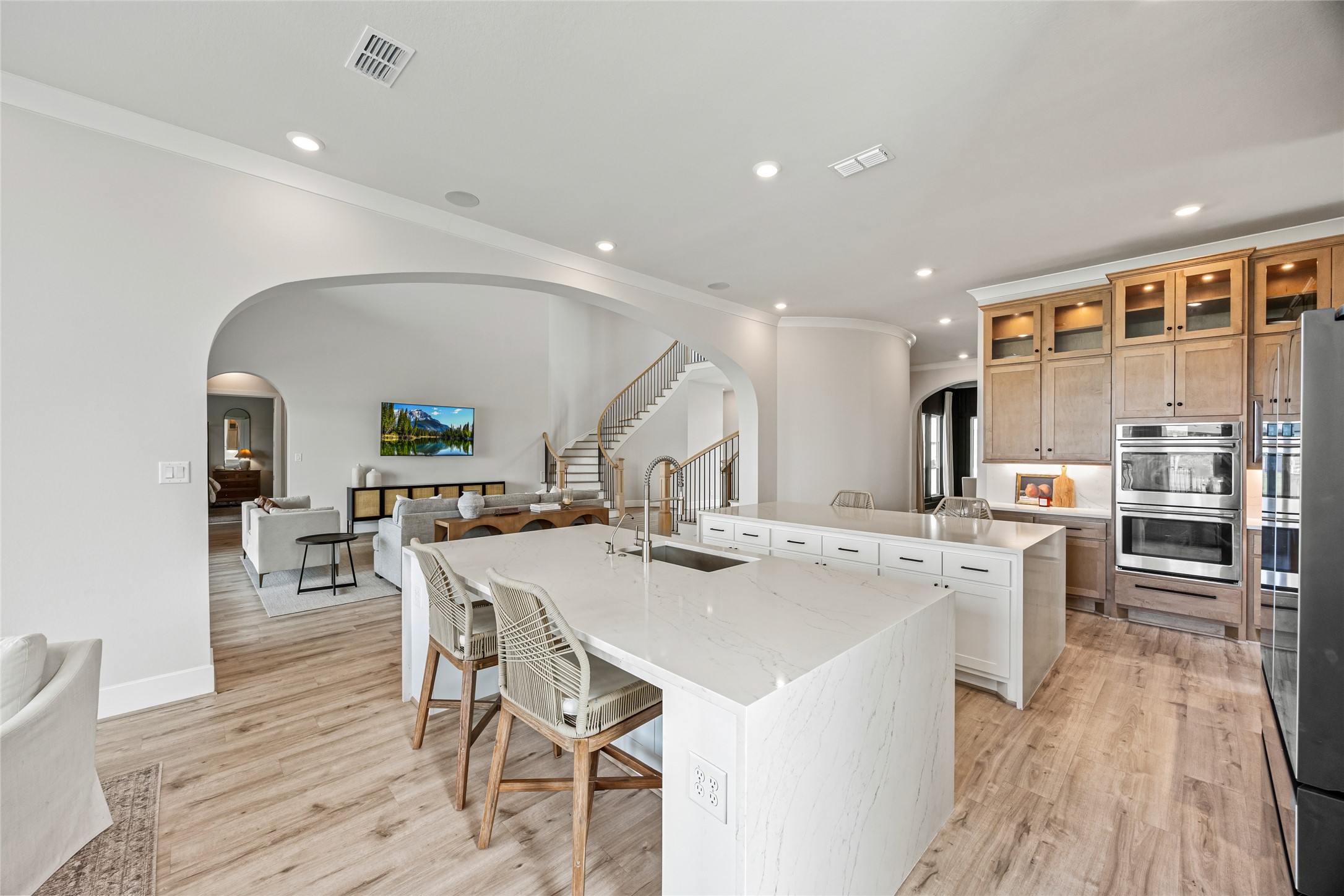 Opulent marble double islands create a striking focal point, perfect for culinary creativity and sophisticated entertaining