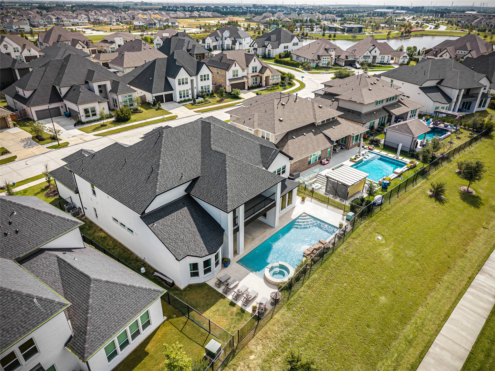 Spacious backyard with water views, perfect for adding your dream pool (virtually staged)