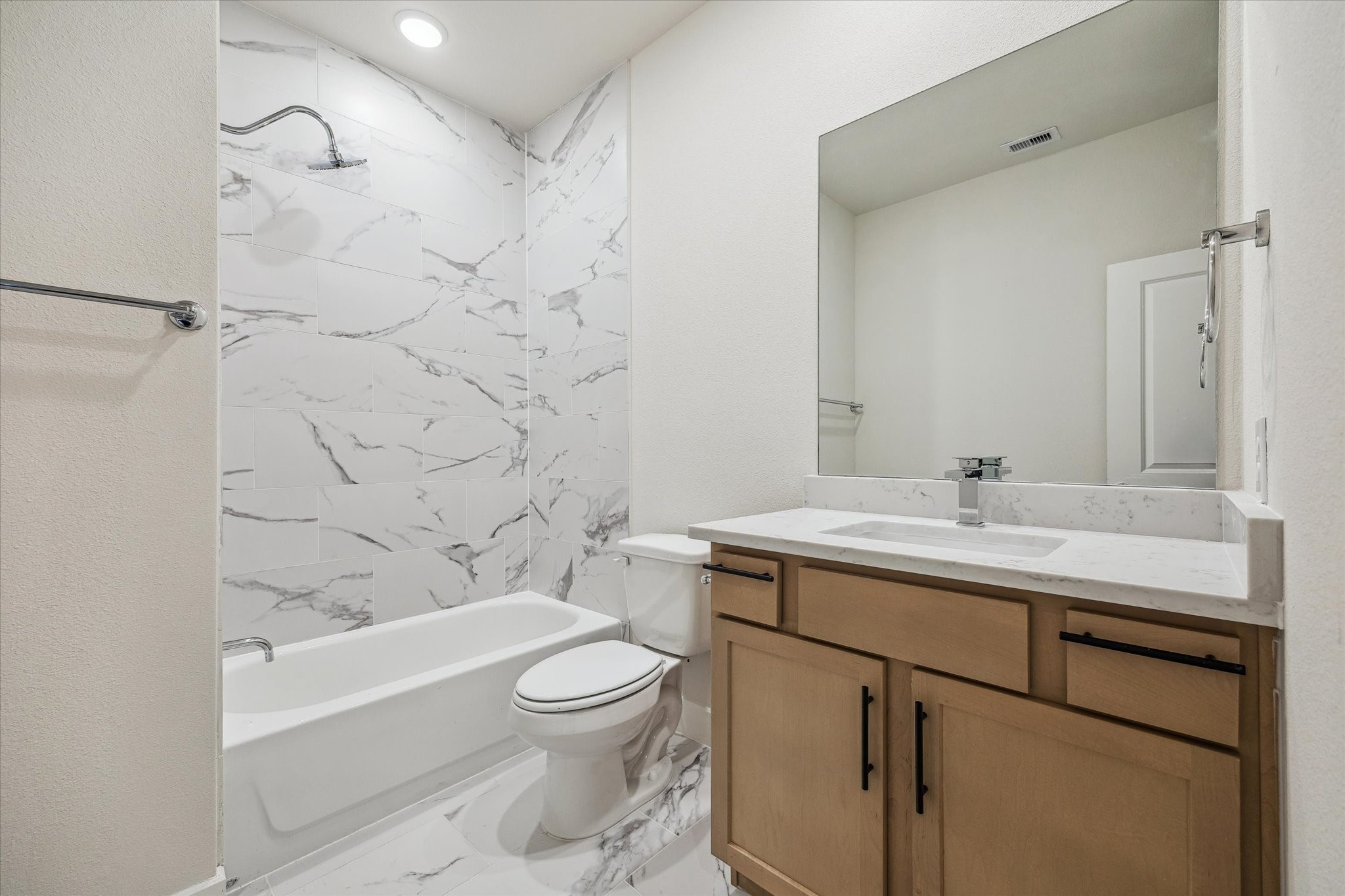 Representative photo of secondary bedroom's bath. Layout and selections may vary.