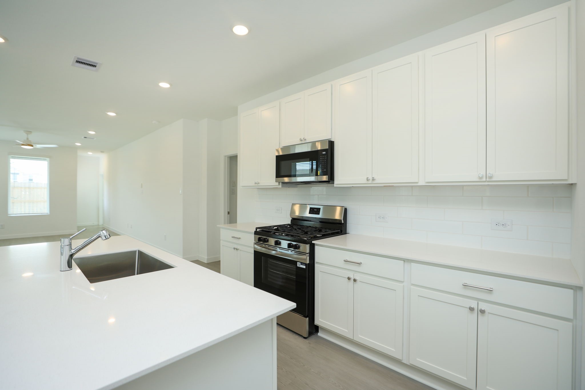 Another view of kitchen with large island.