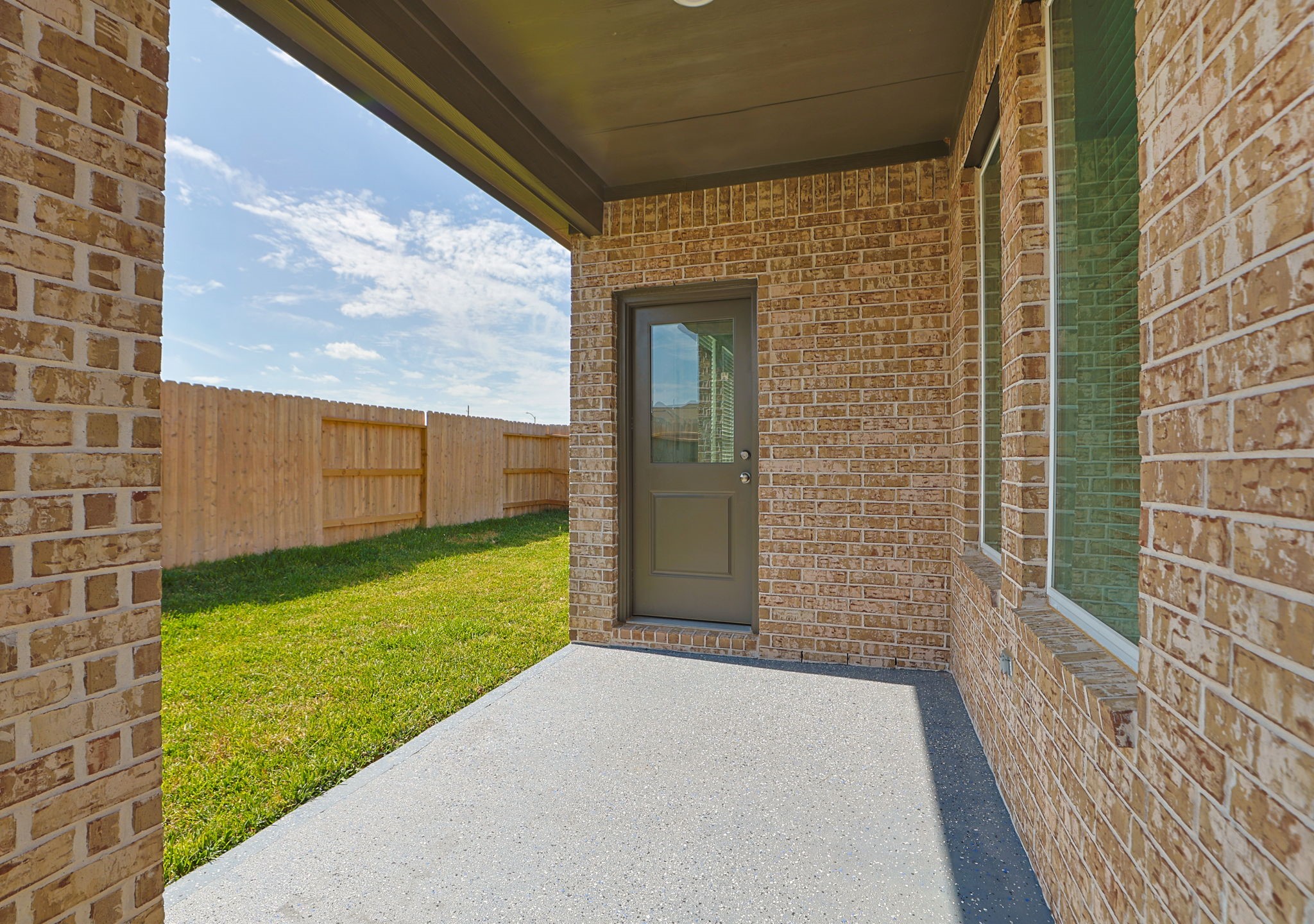 Covered back patio looking onto backyard.