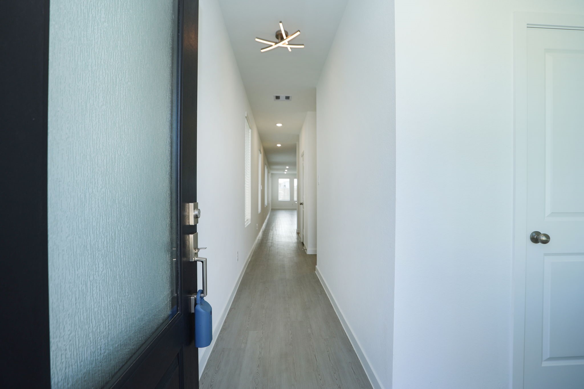 The entry has several tall windows and leads one to the primary living space.