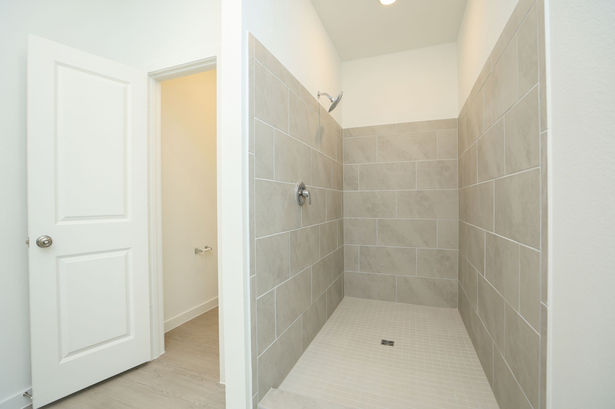Large walkin shower located in primary bathroom.