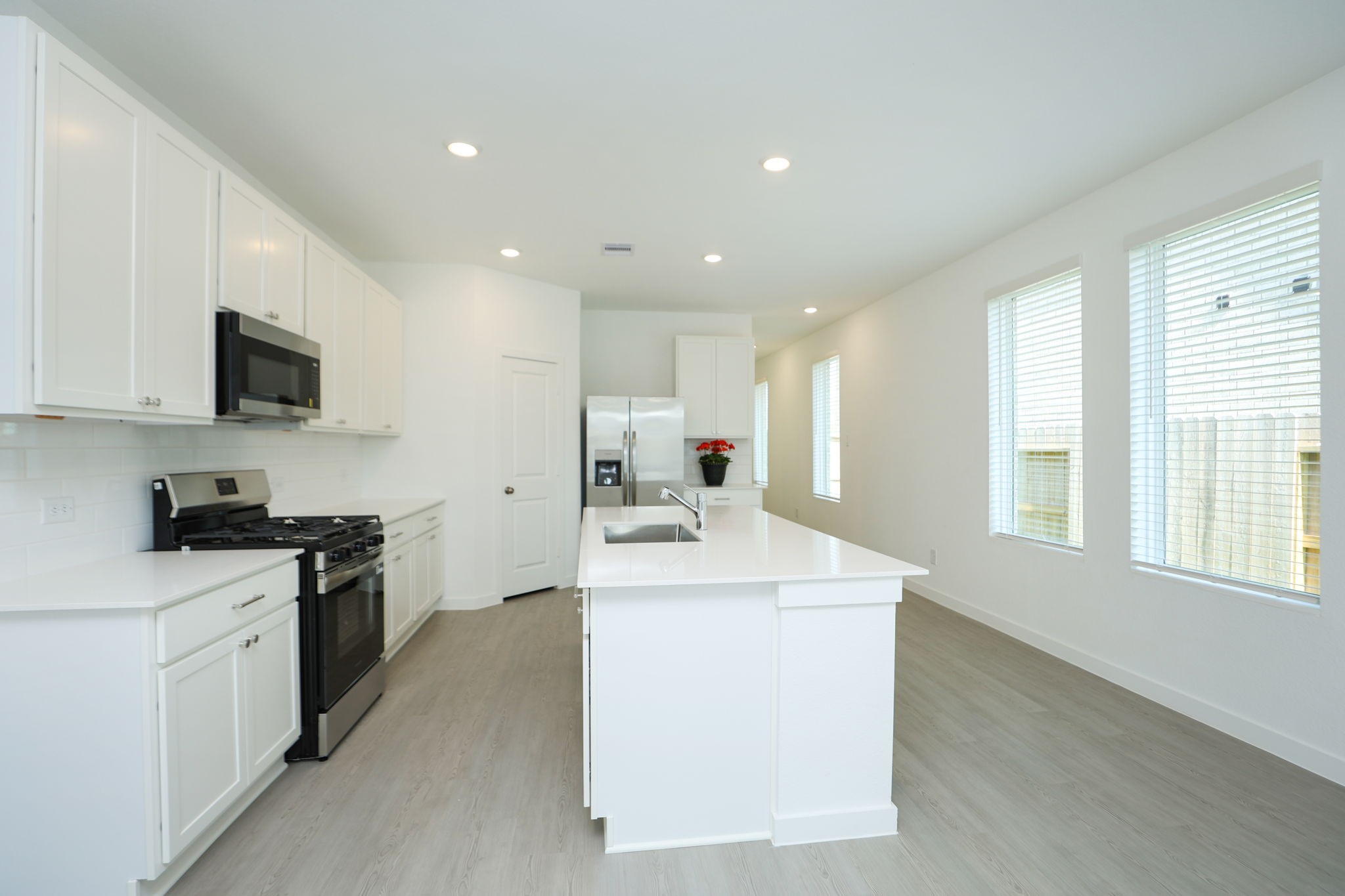 Large windows allow plenty of natural light. Blinds are on all windows.