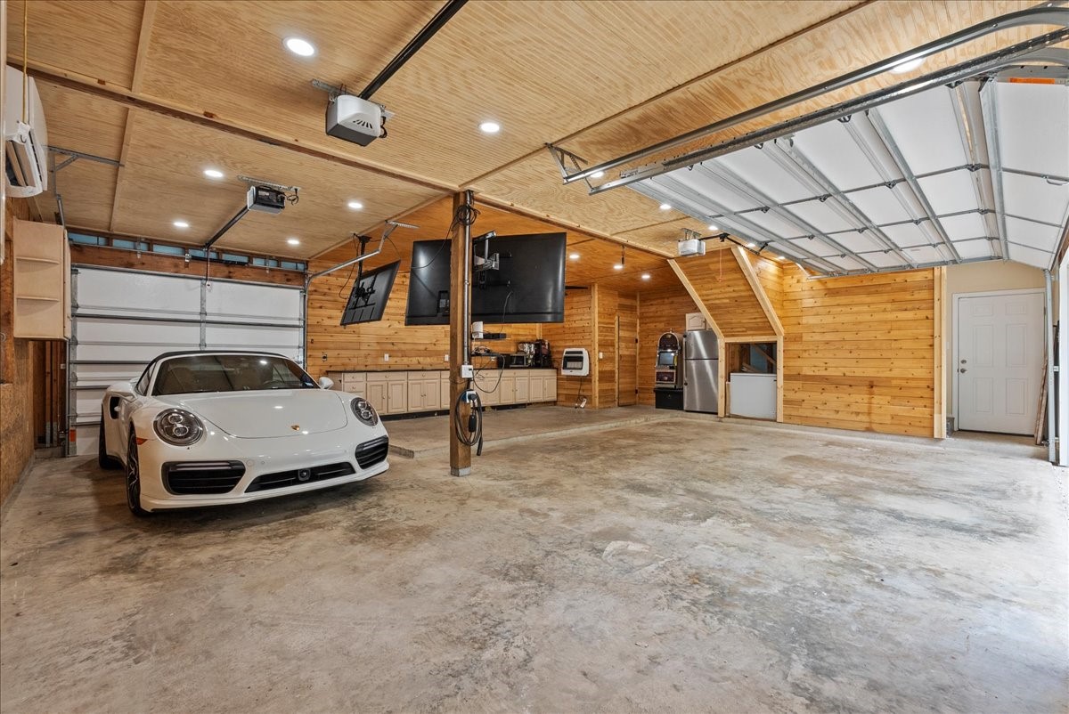A rare find, this oversized climate-controlled garage offers the perfect blend of function and flexibility with four garage doors, a downstairs half bath, and plenty of room for vehicles, storage, or your favorite projects. This impressive space elevates the home beyond the ordinary and provides comfort year-round. A rare find, this oversized climate-controlled garage offers the perfect blend of function and flexibility with four garage doors, a downstairs half bath, and plenty of room for vehicles, storage, or your favorite projects. This impressive space elevates the home beyond the ordinary and provides comfort year-round.