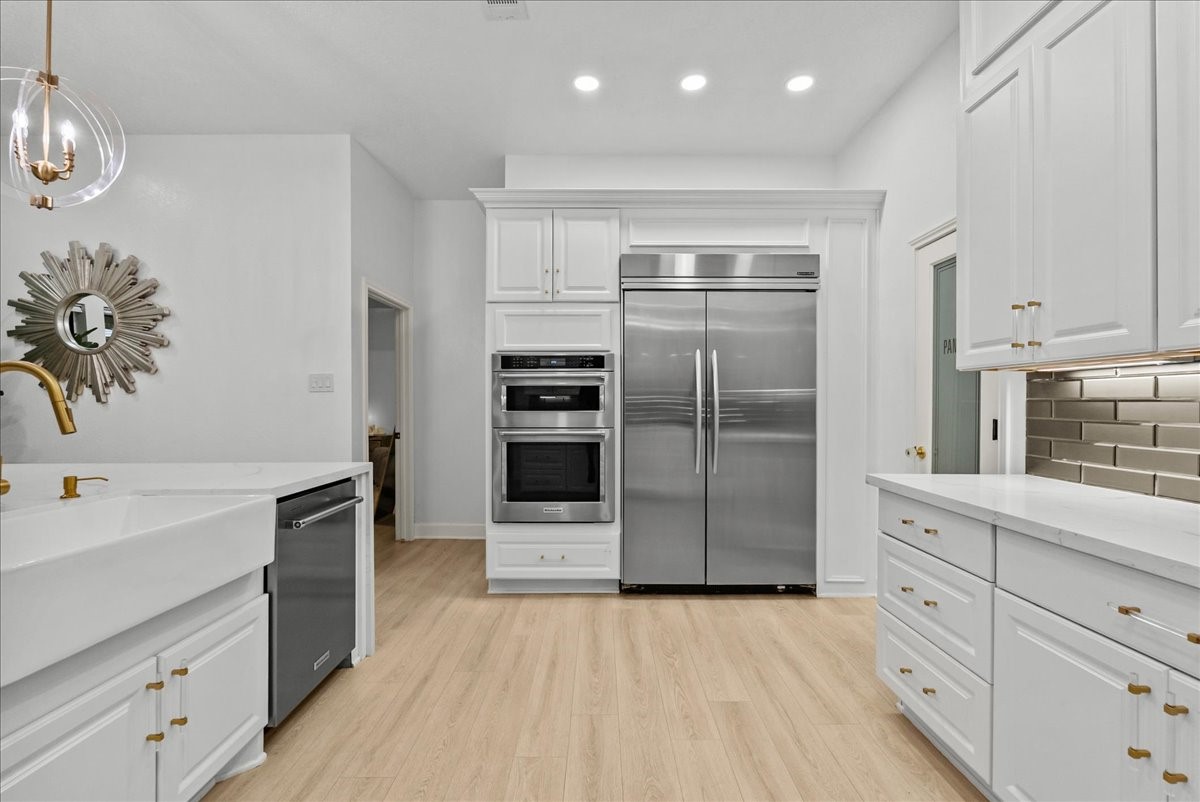 Thoughtfully designed with custom built-in appliances, a gas cooktop, under-cabinet lighting, and exceptional craftsmanship, this kitchen was created for those who appreciate both beauty and performance.
