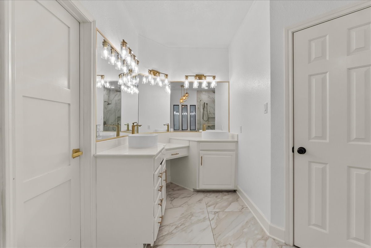 Designed for both beauty and function, this elegant primary retreat features separate vanities with a dedicated sitting area and an expansive walk-in closet offering exceptional space and storage.