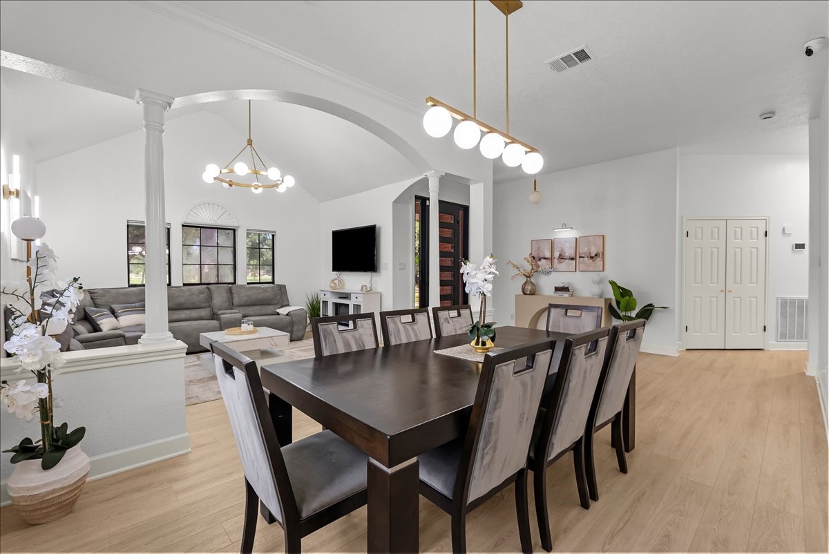 Beautifully appointed, the formal dining room pairs classic architecture with a designer gold light fixture, creating an inviting space for celebrations both large and small.