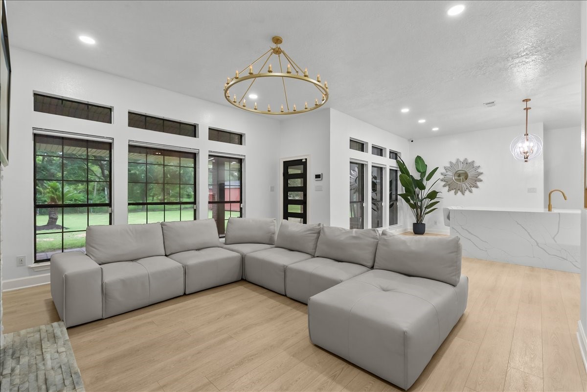 A wall of expansive windows fills the room with natural light, bringing the outdoors in and creating a bright, open atmosphere that feels welcoming all day long.