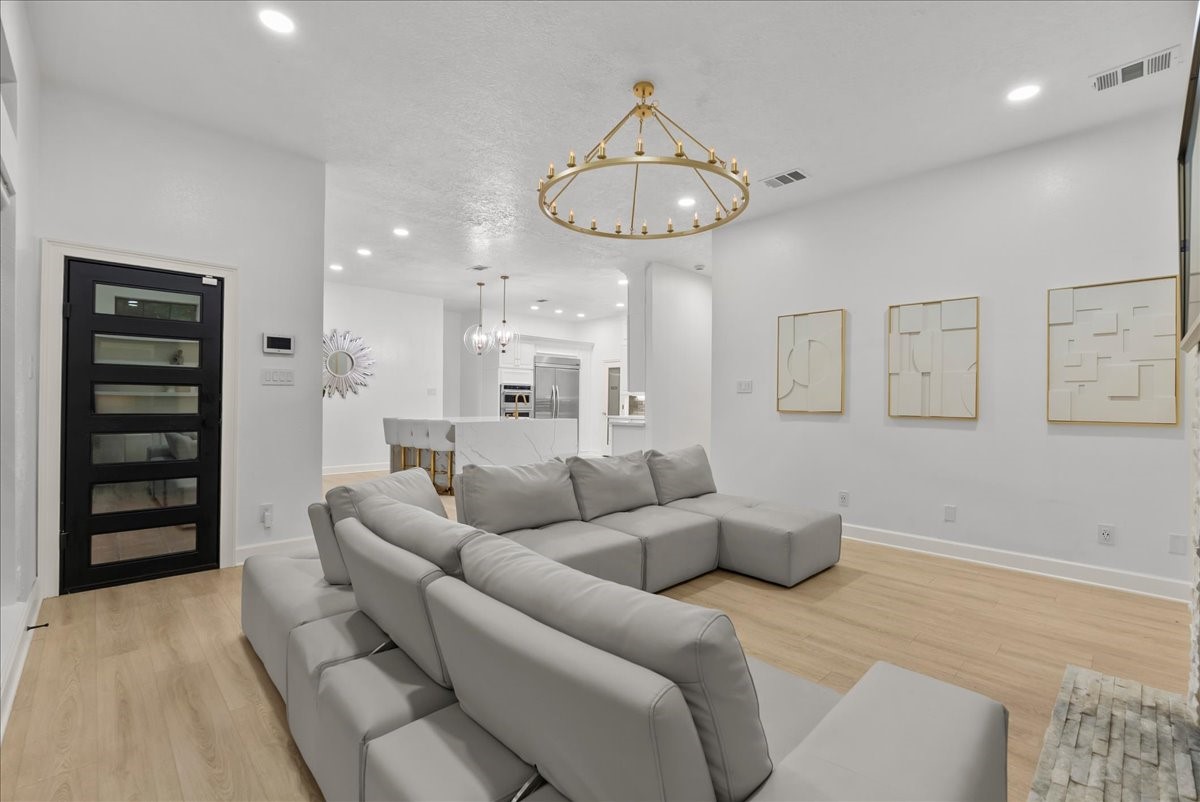 From the custom rear entry door to the elegant built-in cabinetry and statement chandelier, every detail has been thoughtfully selected to create a space that's both functional and refined.